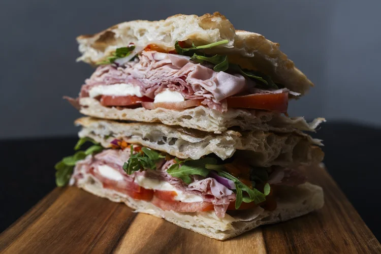 A close view of Florenza’s filled panini on a wooden board