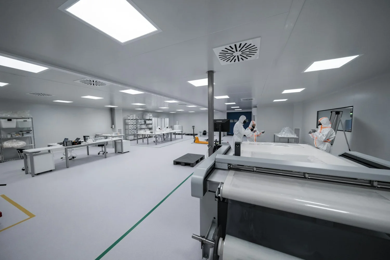 Cleanroom technicians with semiconductor manufacturing equipment