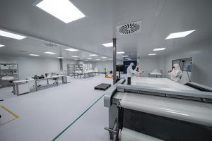 Cleanroom technicians with semiconductor manufacturing equipment