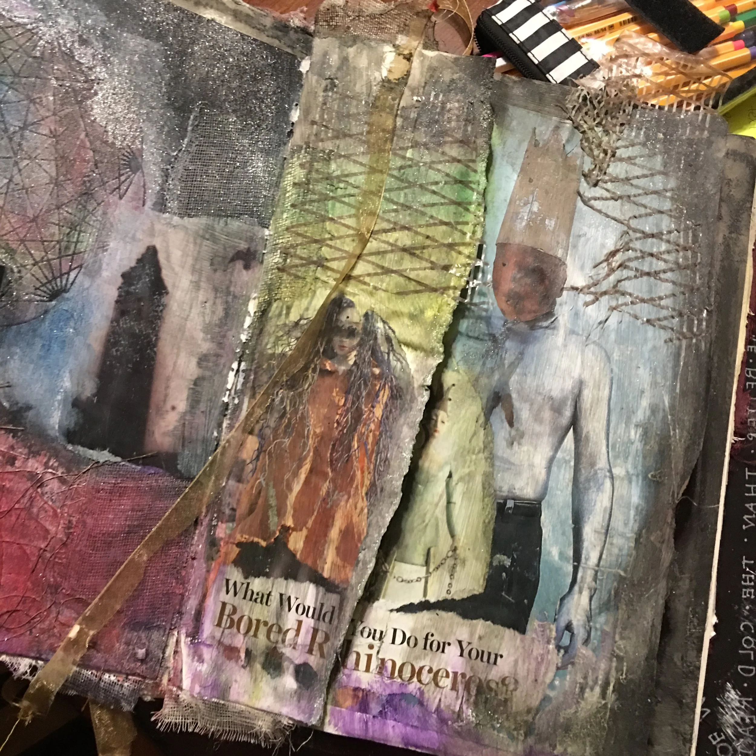 Mixed media and art journal spread with layered textures and ink