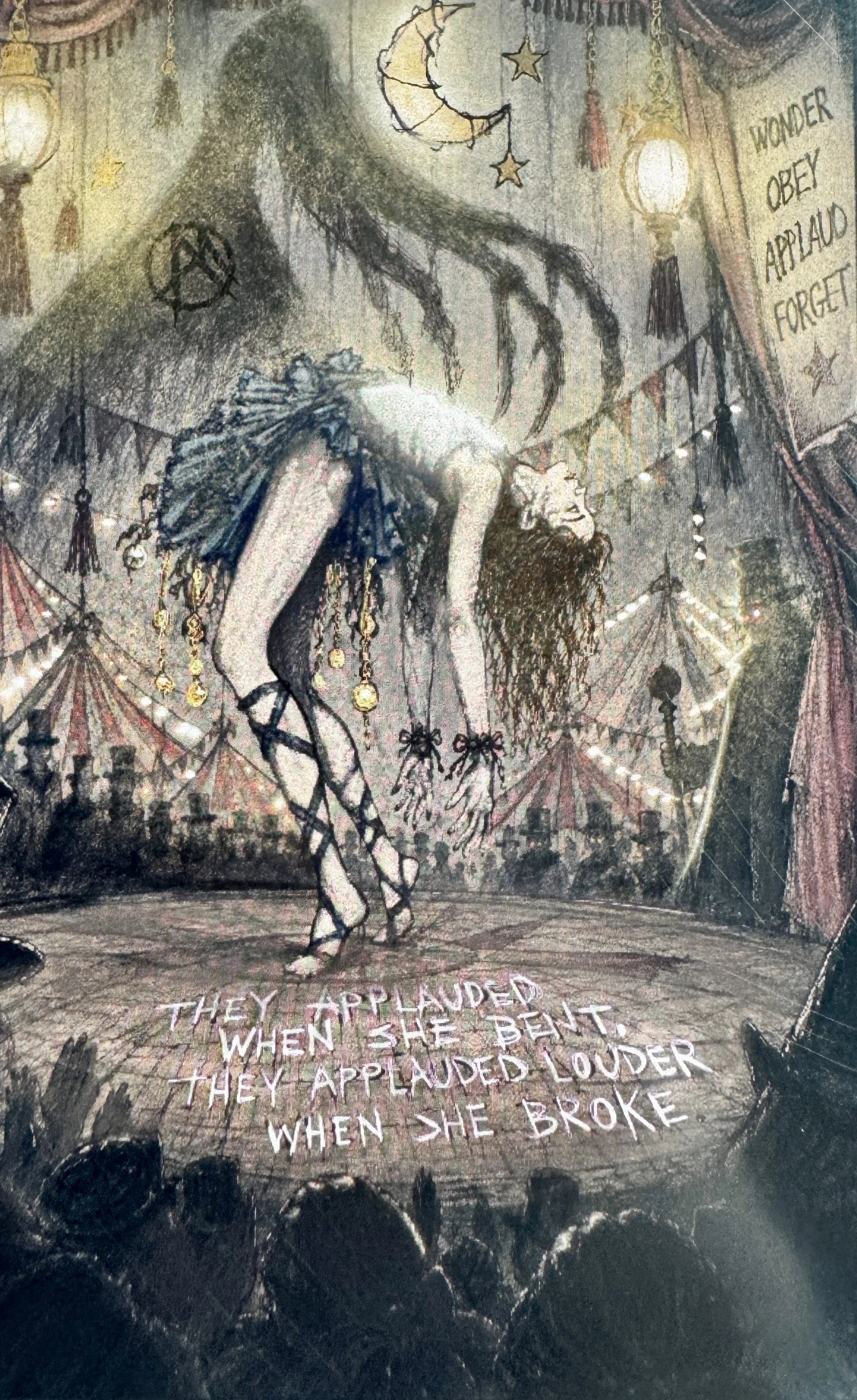 Contortionist performing beneath the carnival lights while the audience watches