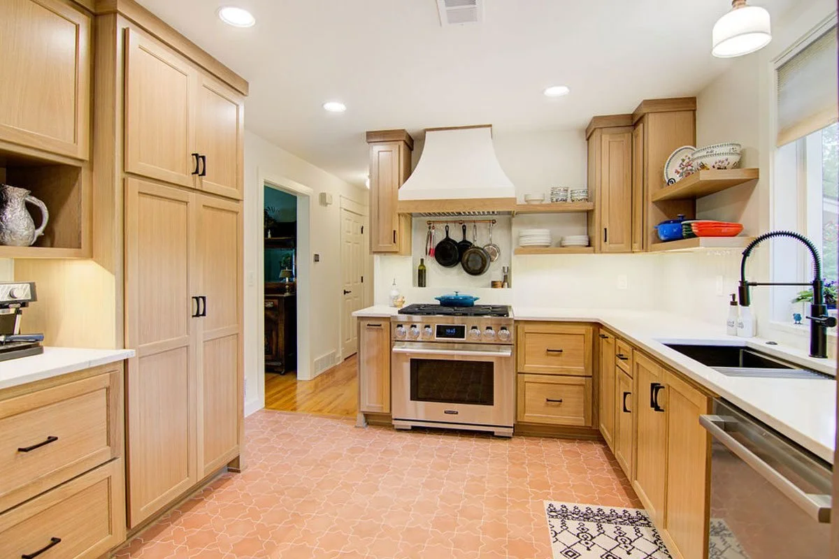 Warm oak kitchen with custom range hood