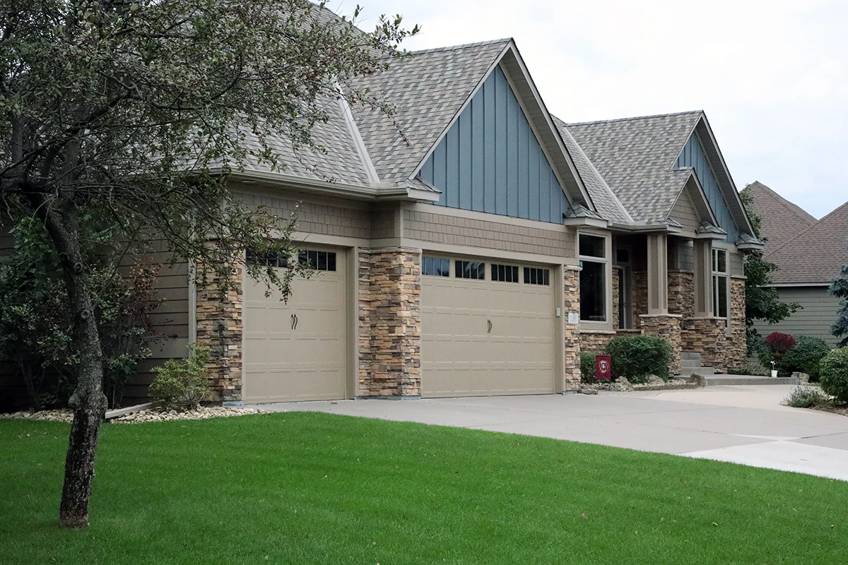 Exterior siding and roofing installation by Advanced Roofing and Siding Inc. on a Minnesota home showing completed workmanship and clean job site