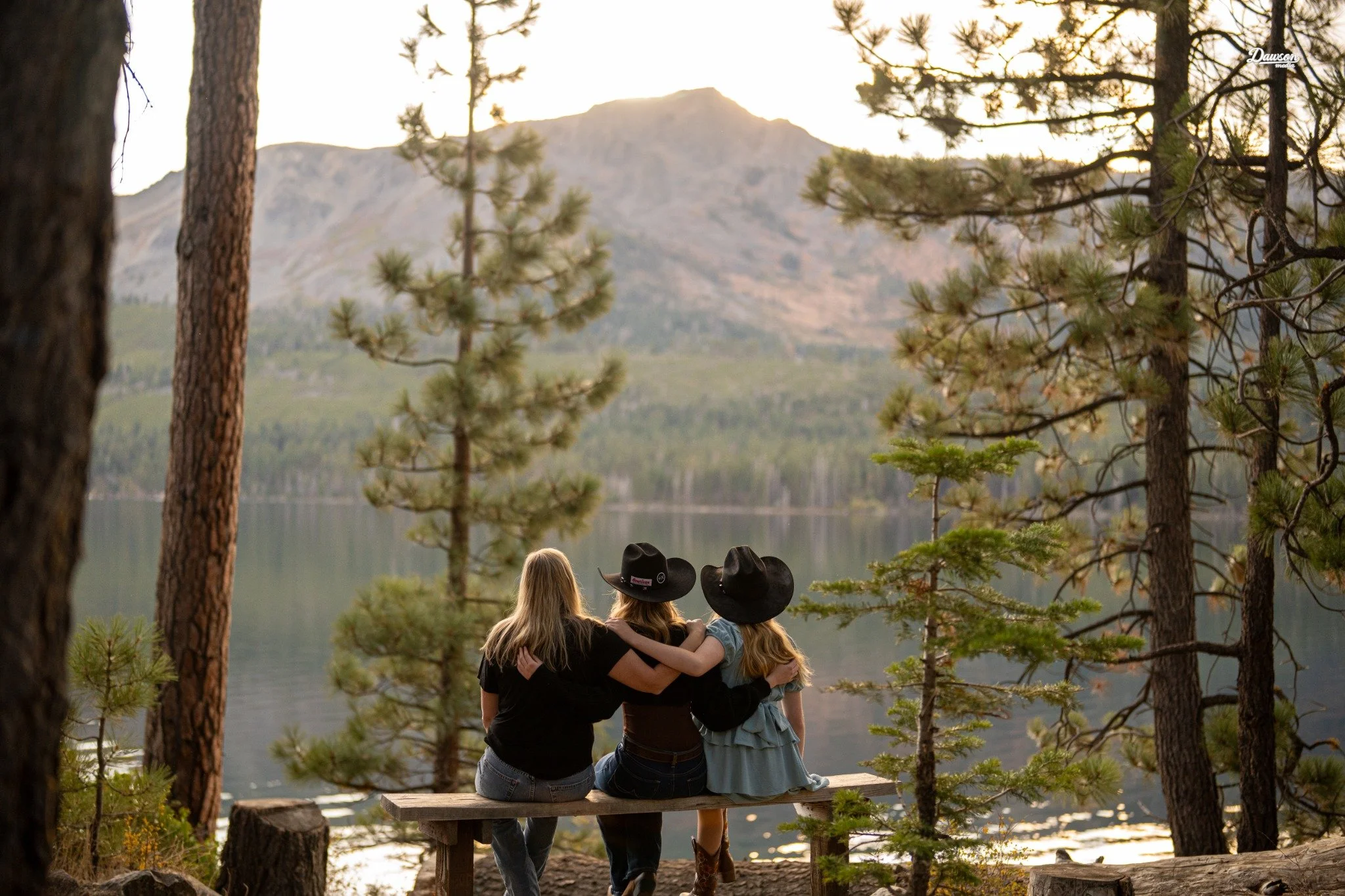 Three friends sharing a quiet moment beside Lake Tahoe