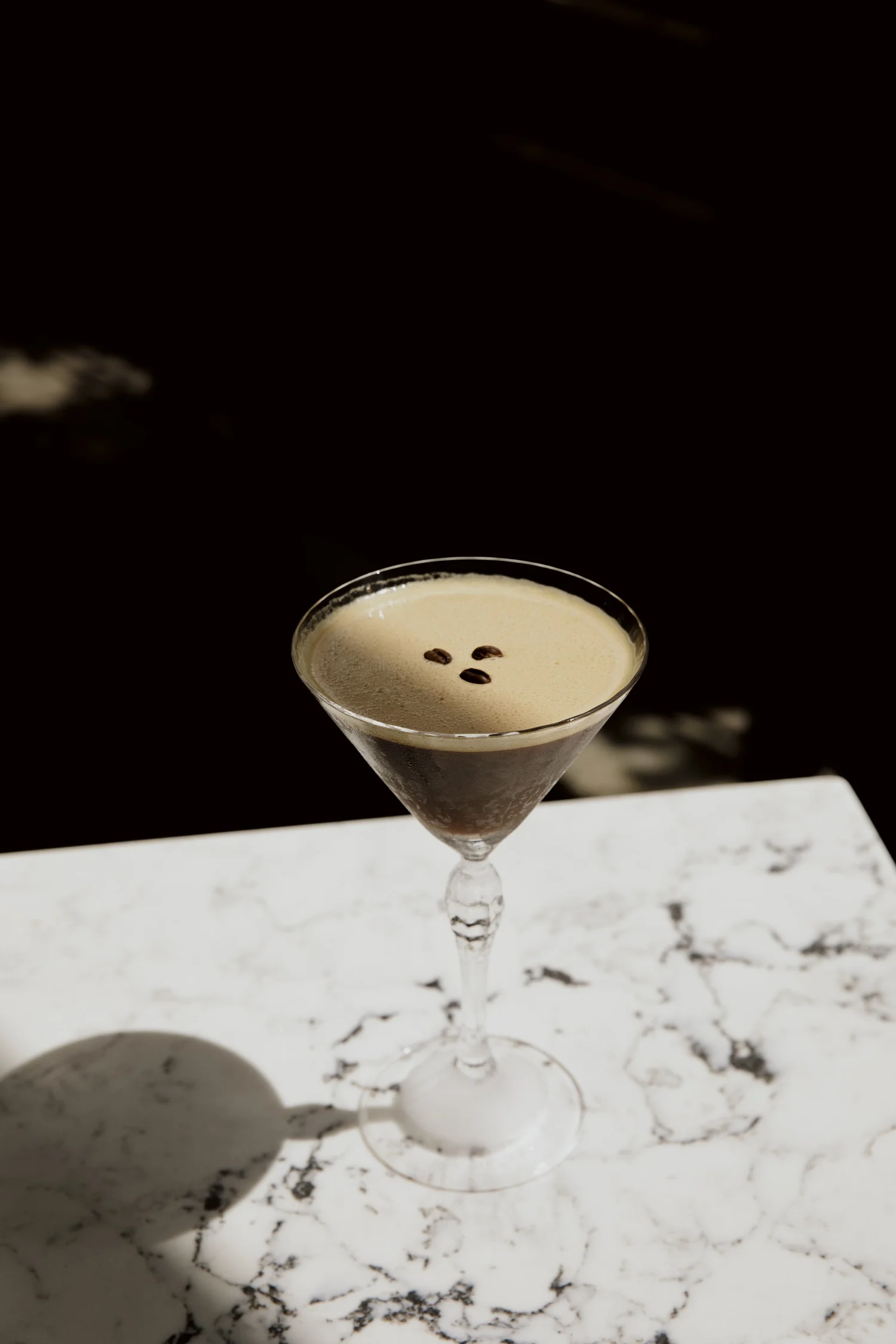 An espresso martini on white marble at Salina