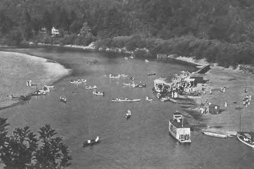 Historic 1909 photo of boats and swimmers at the Russian River beach in Monte Rio