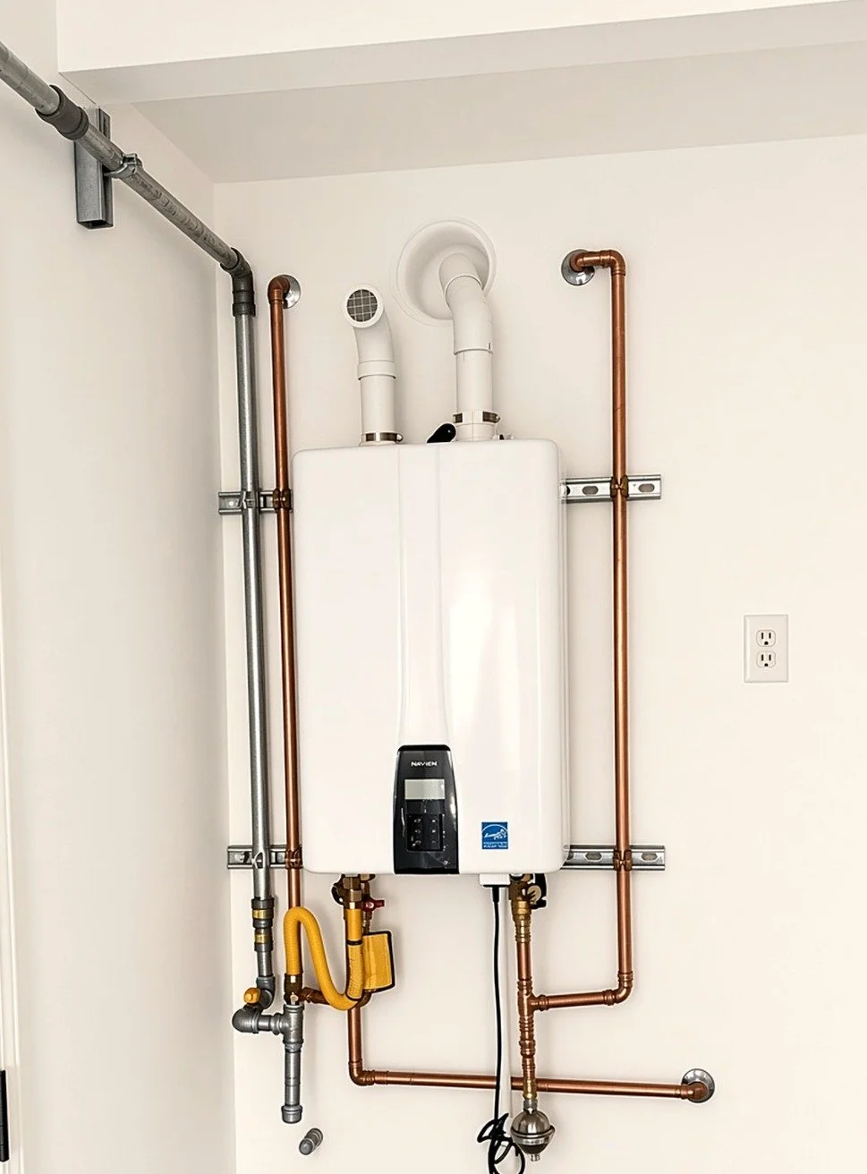 Wall-mounted Navien tankless water heater with copper and gas piping in a Sonoma County home