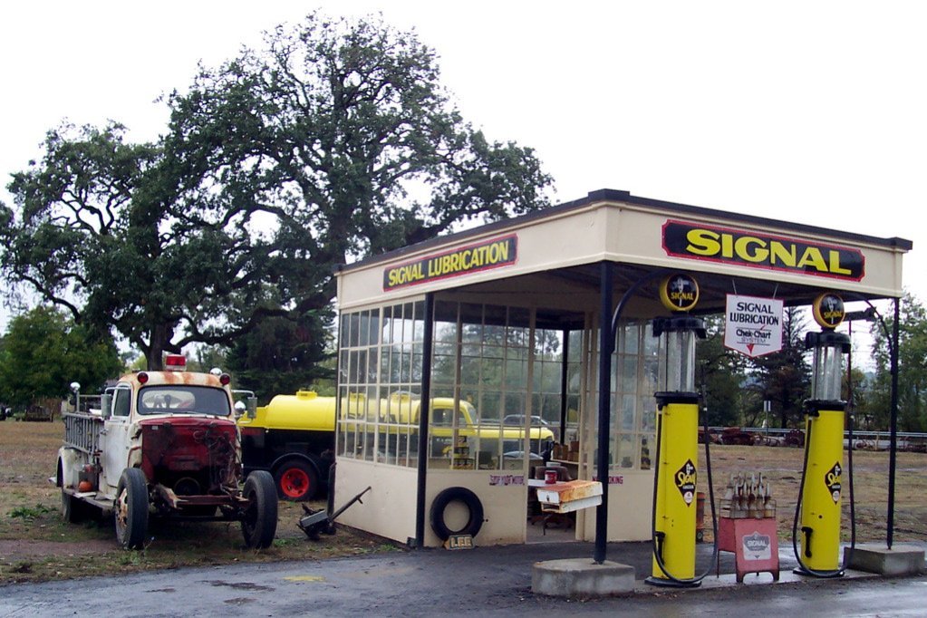 Restored vintage Signal gas station with antique fire truck and gas truck at Stoke Ranch on Old Redwood Highway