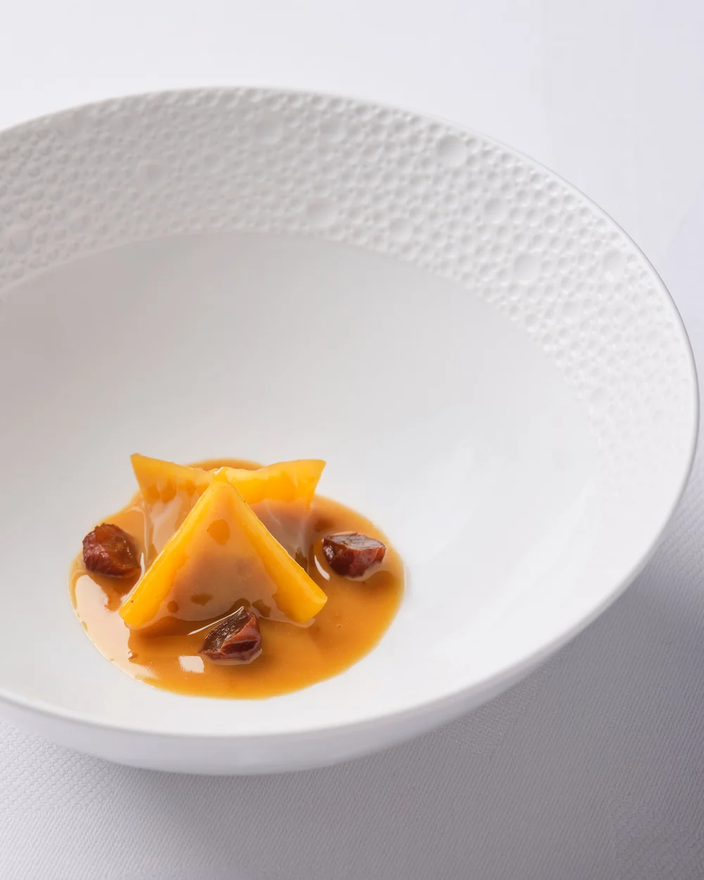 Agnolotti in a white bowl at Sketch - photograph by Claude Okamoto