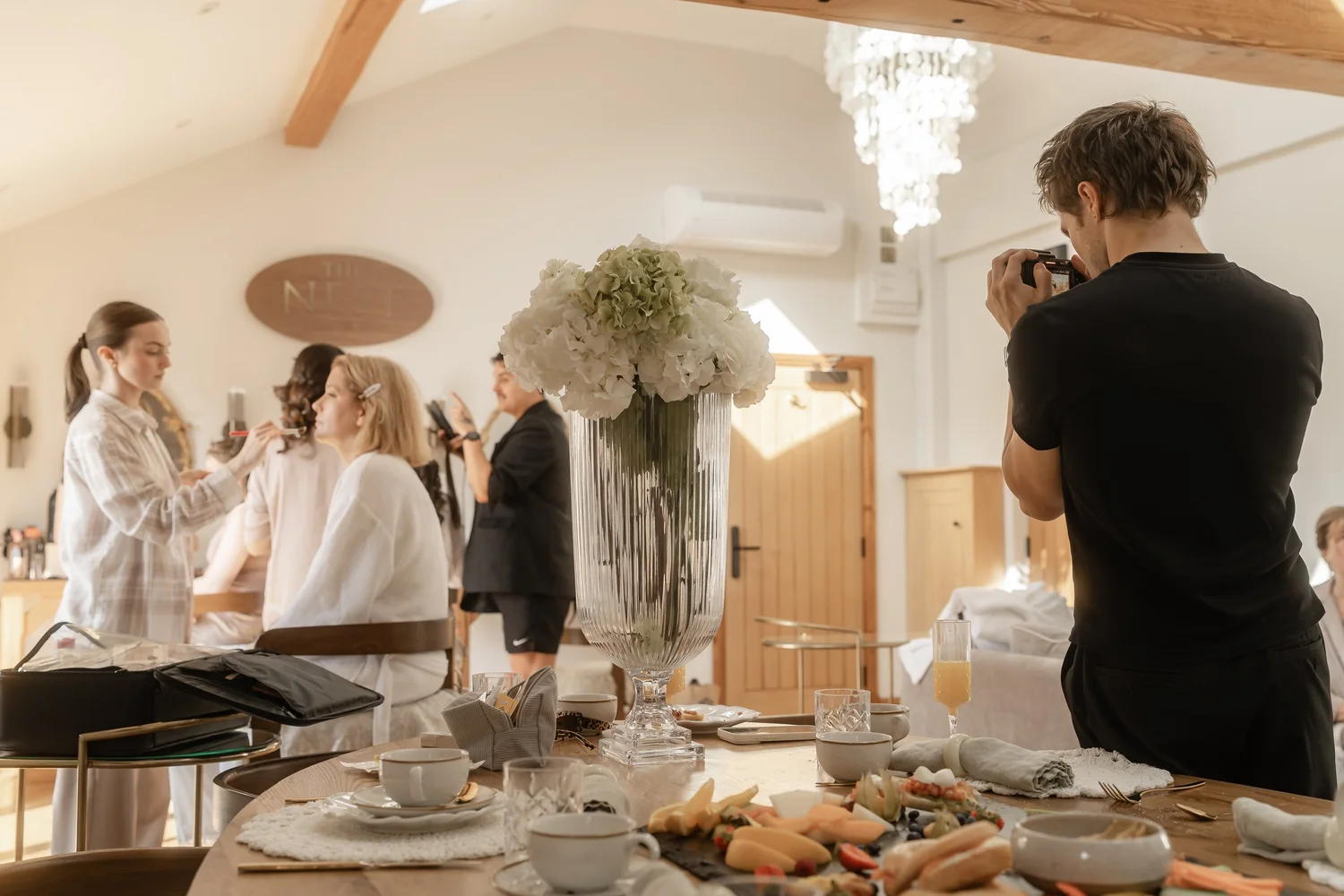 Pierce filming the wedding preparations from the corner of the room