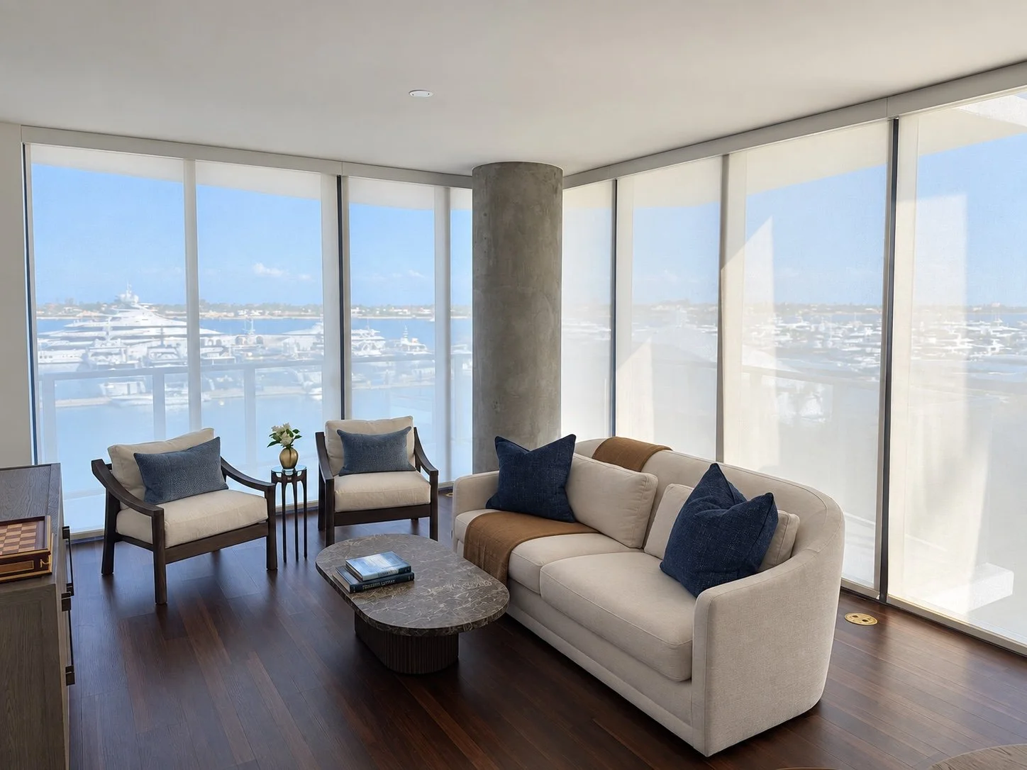 Light-filtering roller shades around a corner window overlooking the water
