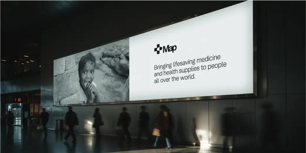 Concept one shown on a large backlit billboard in a dark concourse
