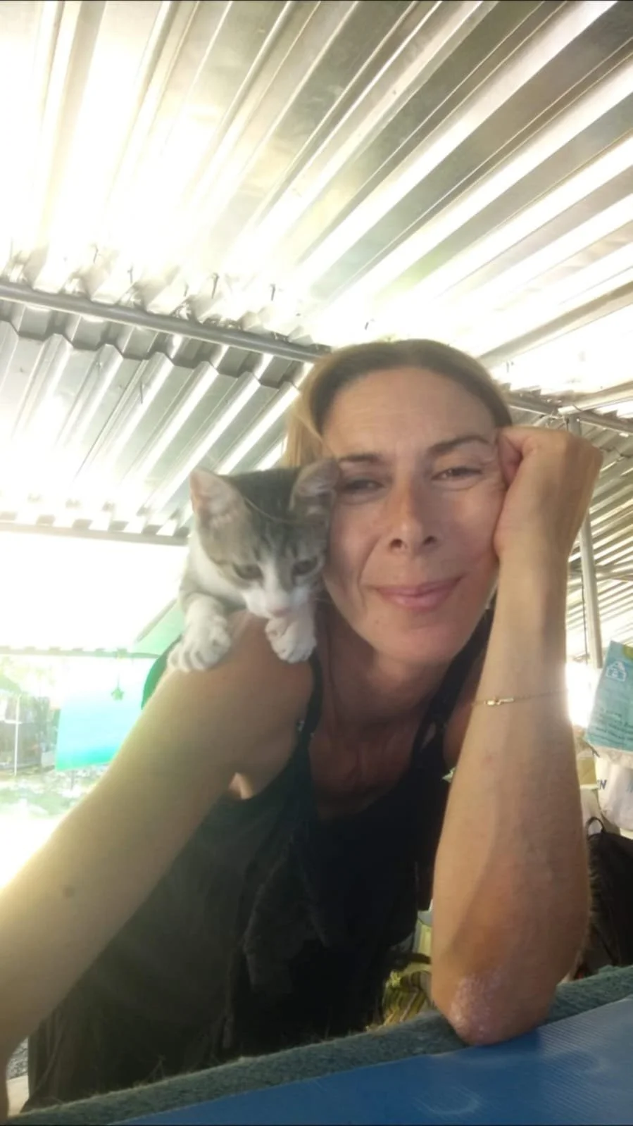 Sofia at the shelter with a kitten on her shoulder