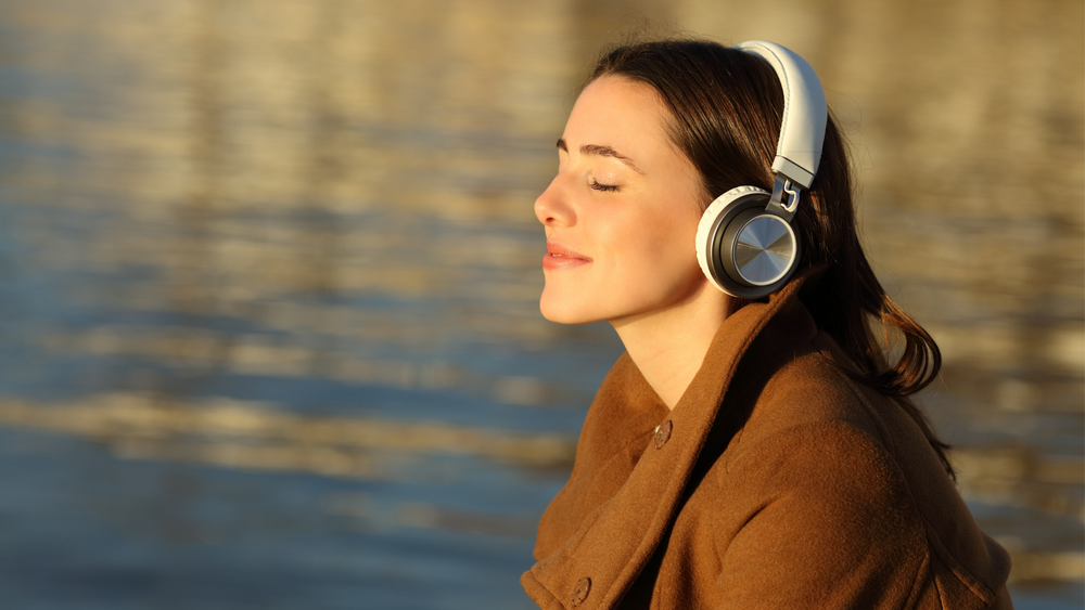A woman listening in headphones