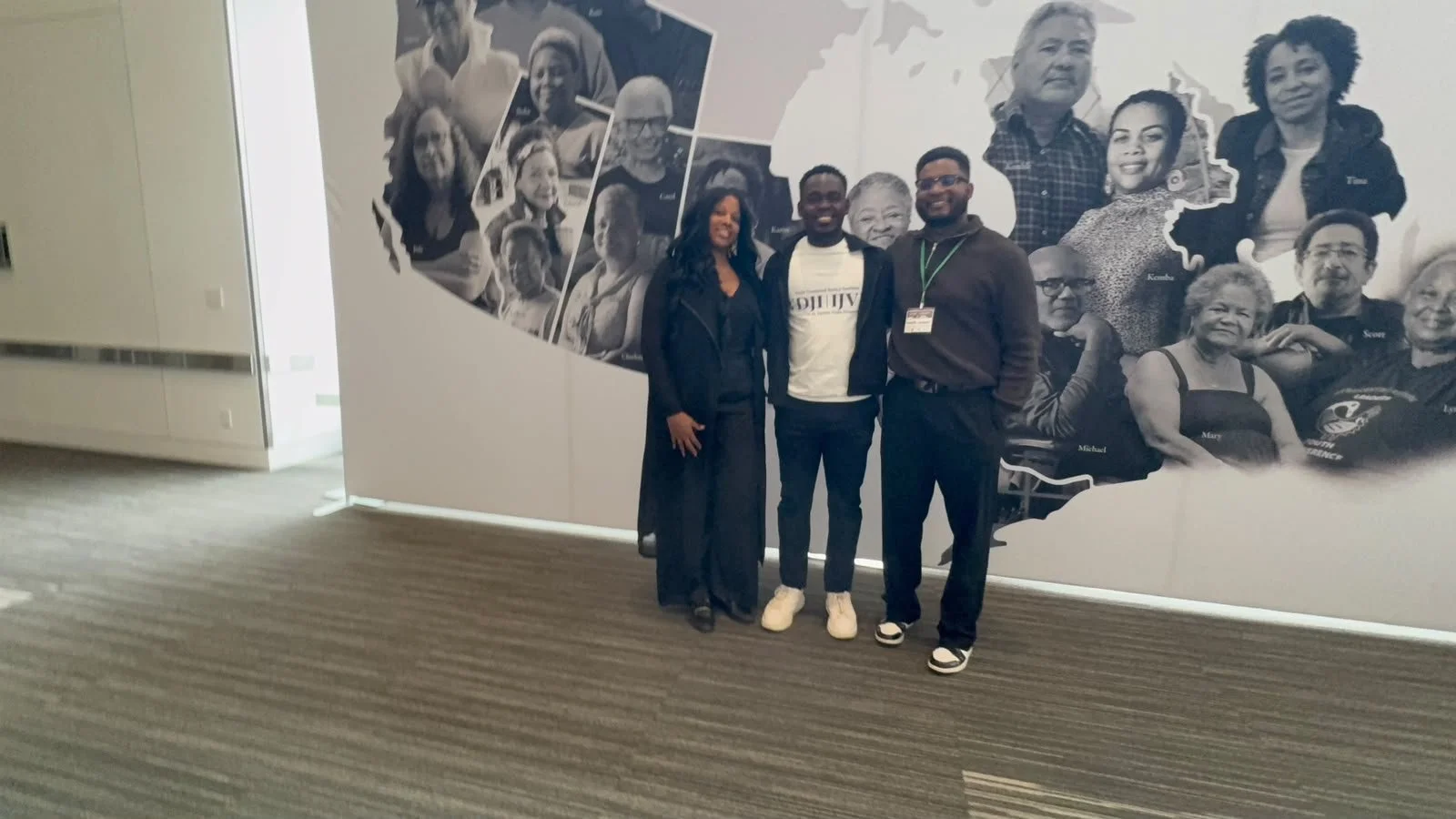 Summit participants alongside an exhibition on Black history.