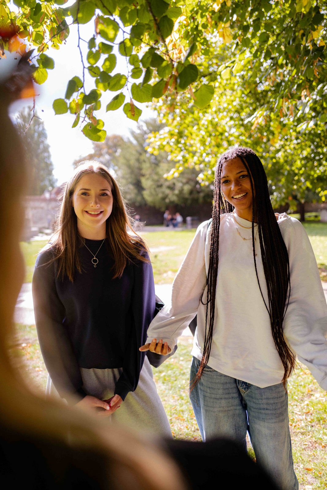 Two students chat outside Winchester Cathedral