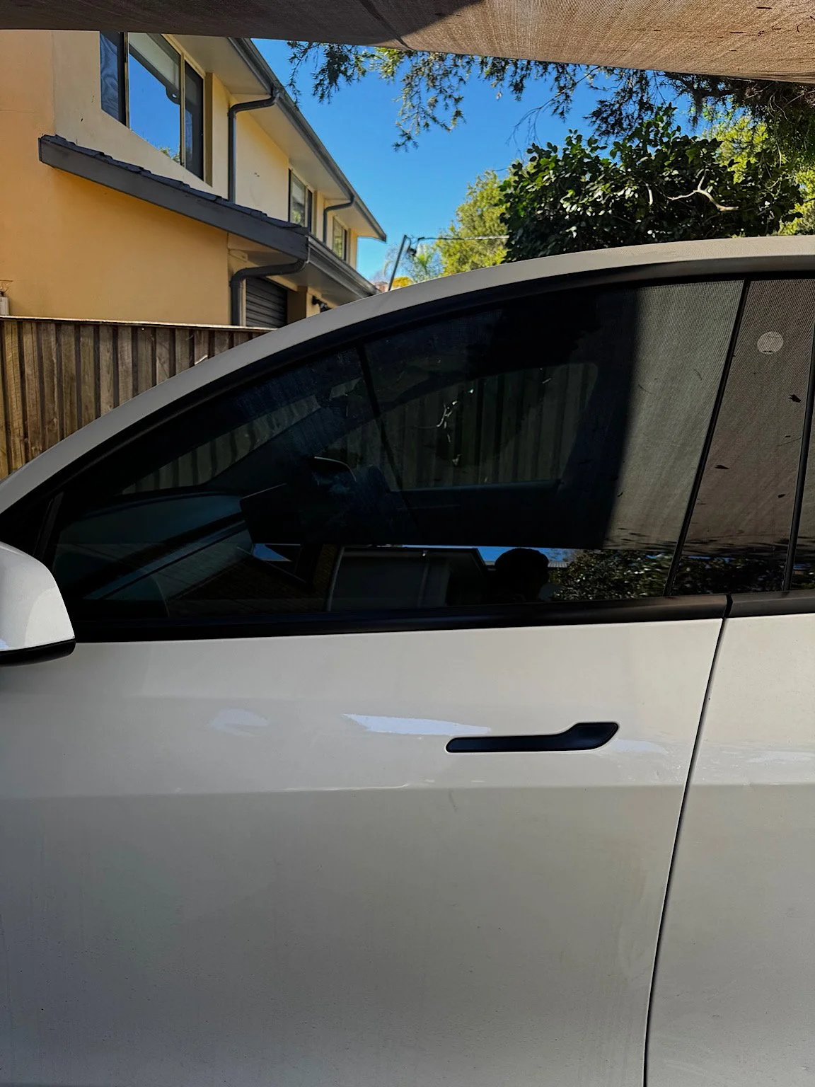 Close view of Tesla Model Y front window finished with 3M Ceramic IR 35% tint