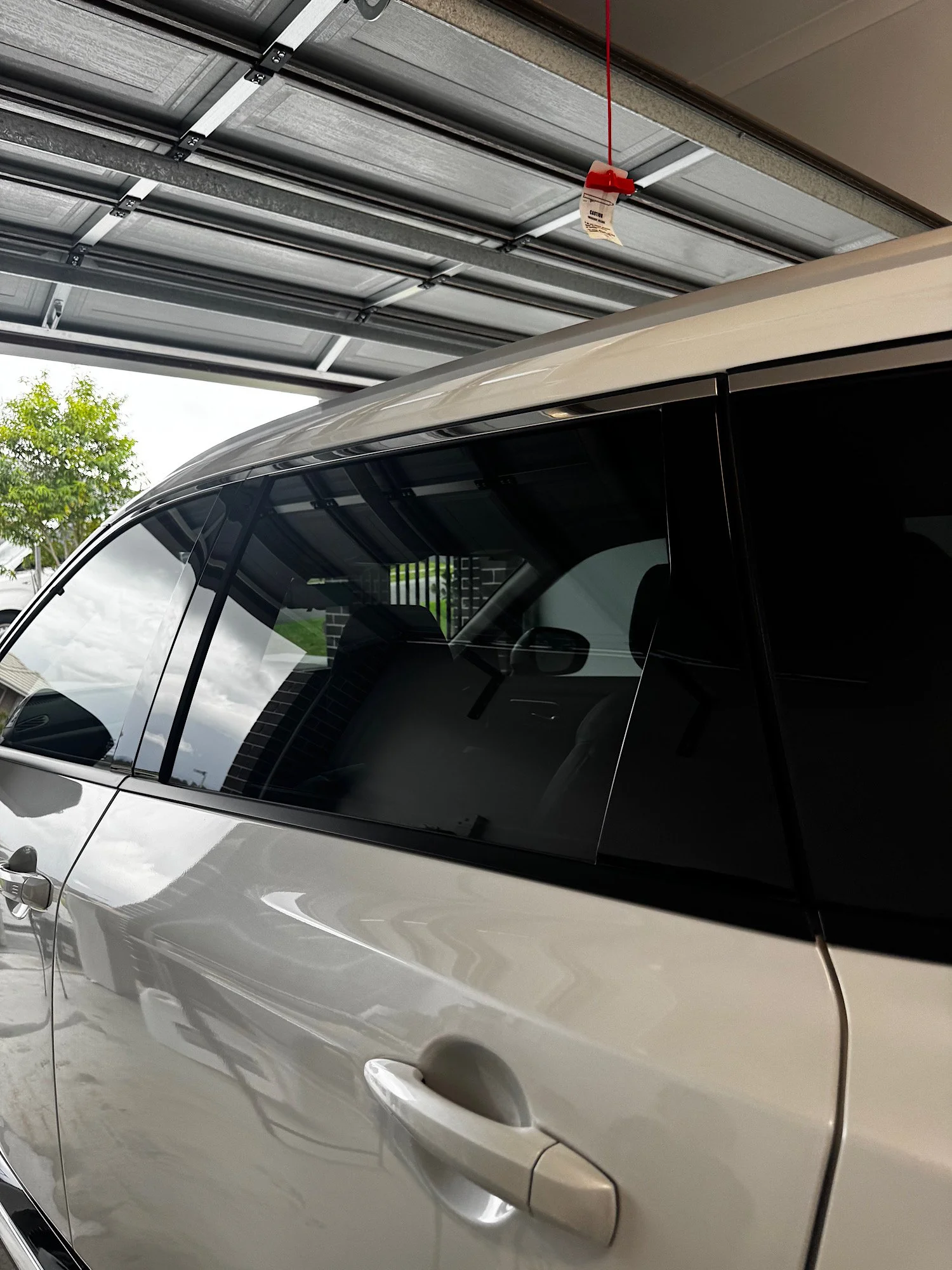 Close-up view of Nissan X-Trail e-4ORCE front door window tint finish