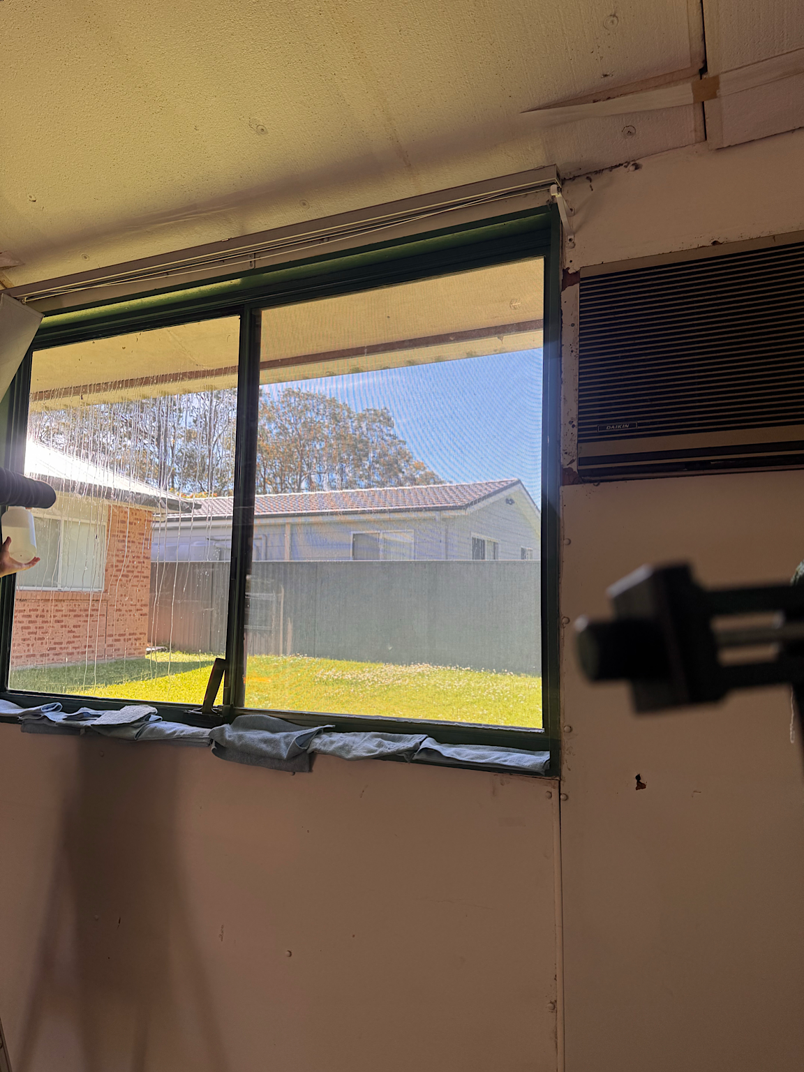 Shed window before tint showing strong sunlight exposure and glare inside Central Coast NSW
