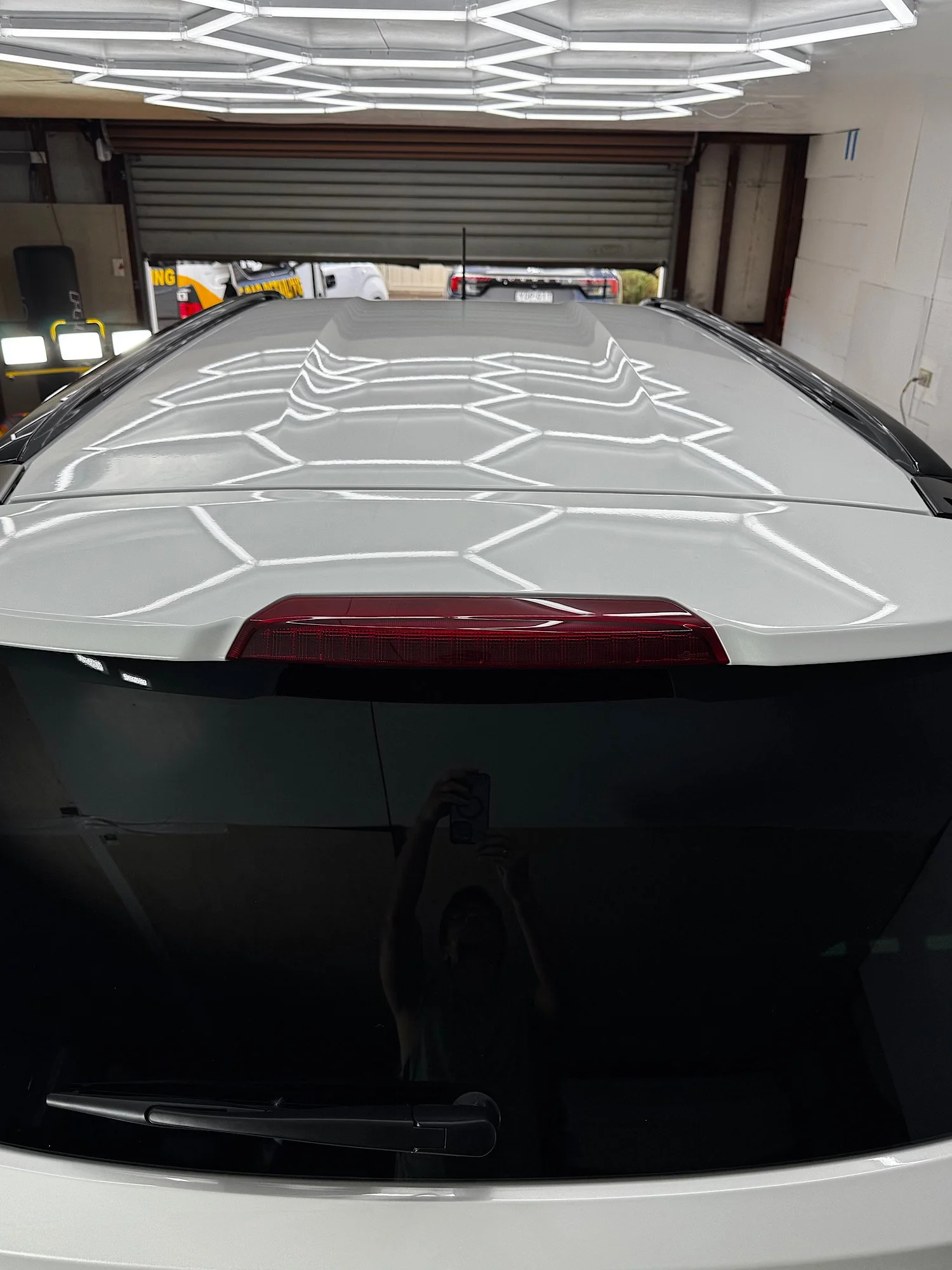 Studio light reflections across the white roof of a 2026 Isuzu MU-X after CSU and EXOv5 ceramic coating