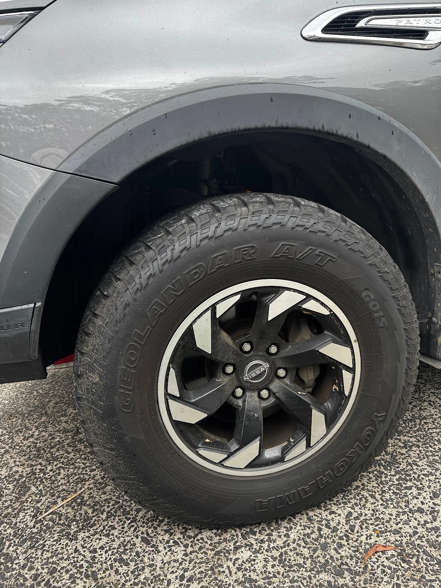 Dirty Nissan Patrol Warrior wheel and tyre with brake dust and dirt buildup before detailing