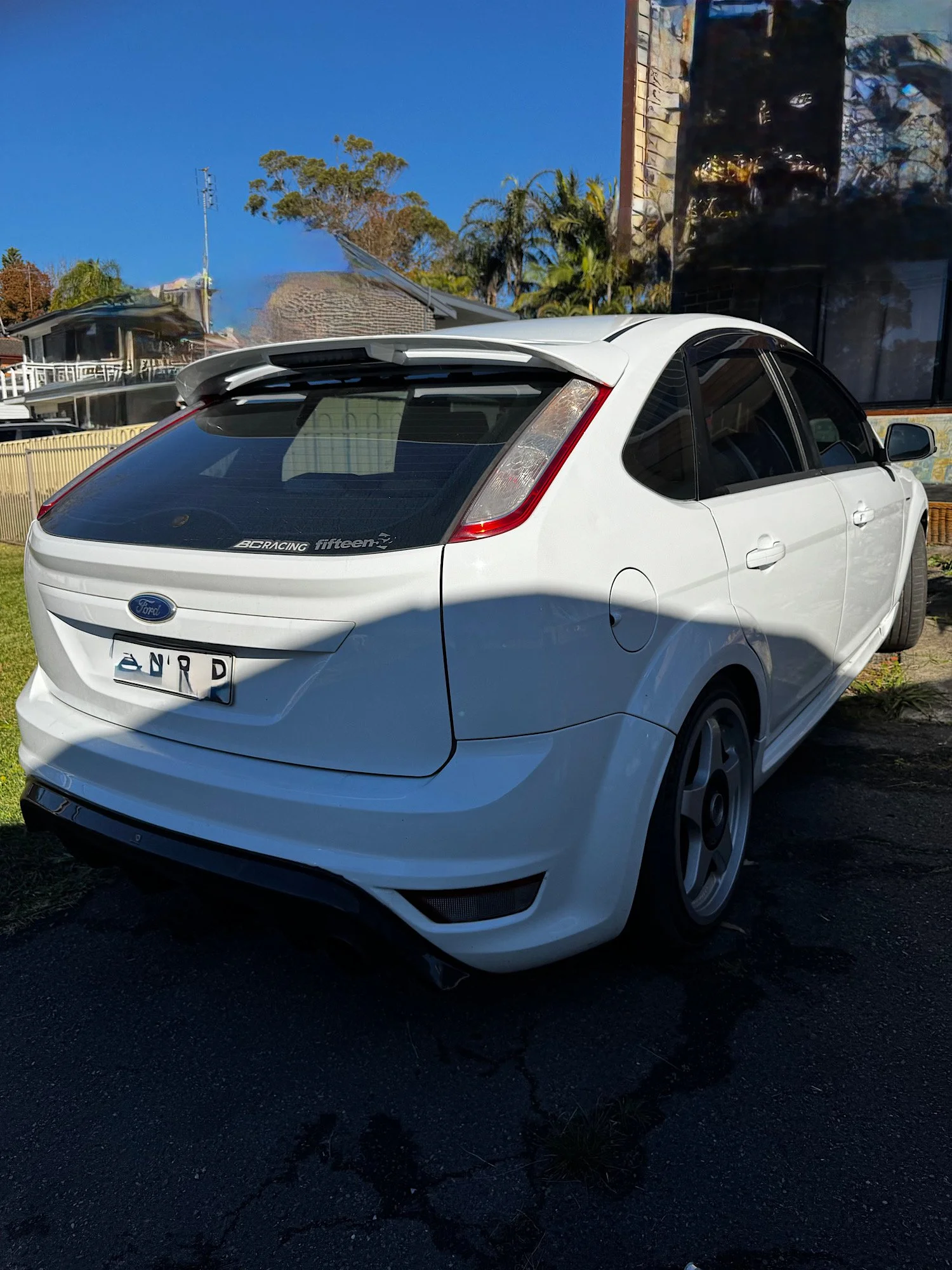 Rear exterior of a 2010 Ford Focus XR5 Turbo before an extended detailing service in Gwandalan NSW.