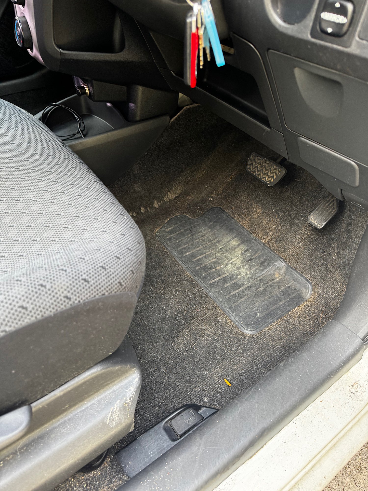 Driver carpet before interior detailing on 2011 Toyota Yaris in Terrigal NSW