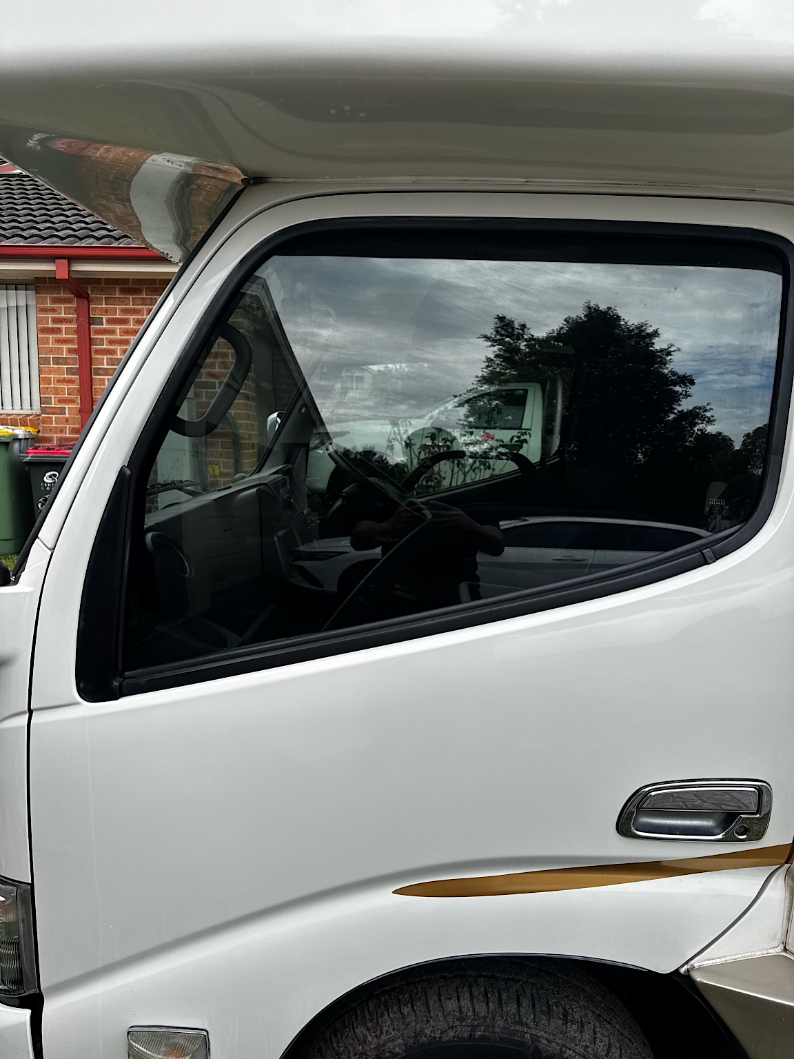 2018 Toyota Camroad campervan cabin window after professional tint installation in Hamlyn Terrace NSW