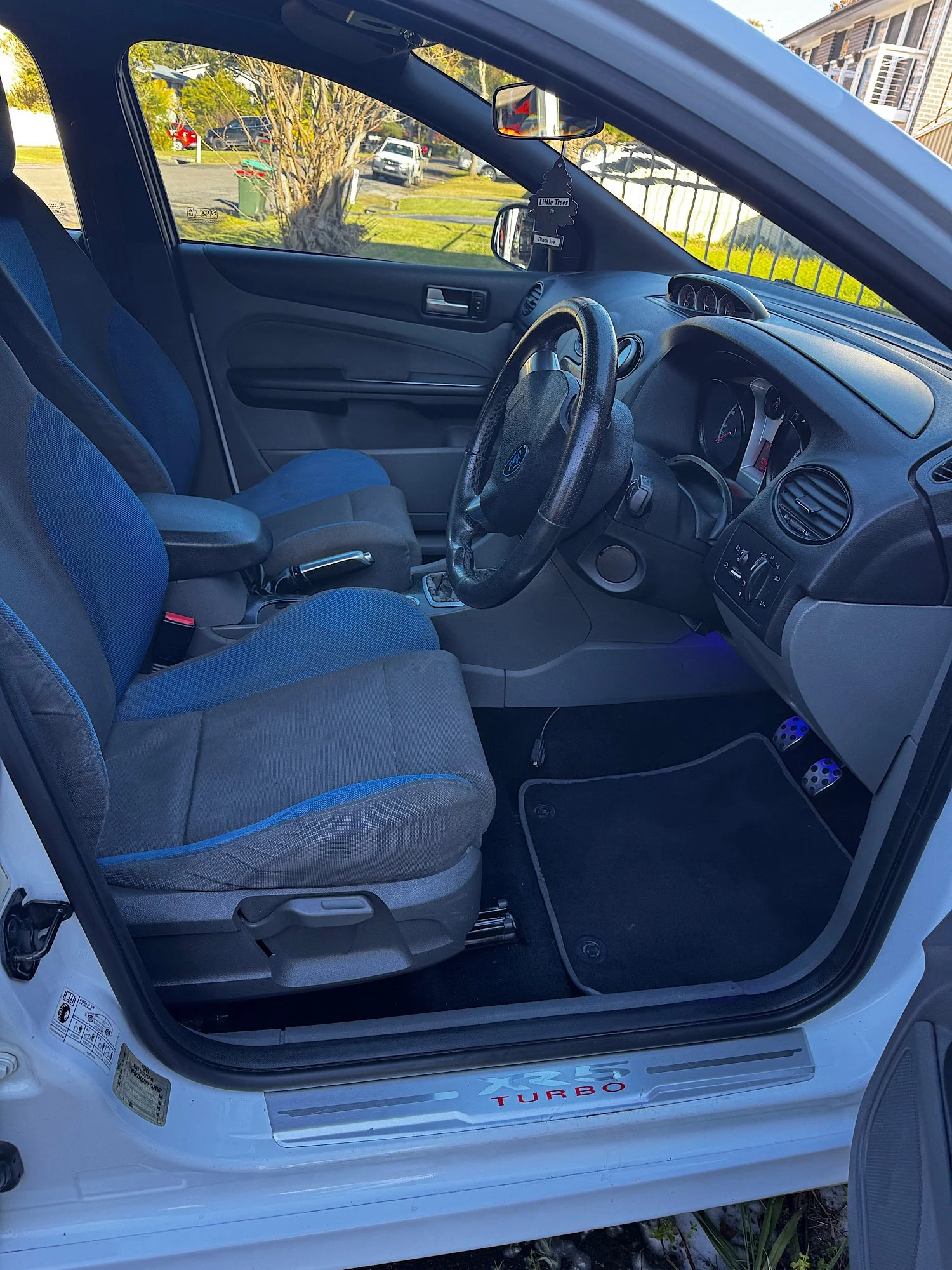 Driver interior after an extended detailing service with cleaned carpets, dashboard and seats.