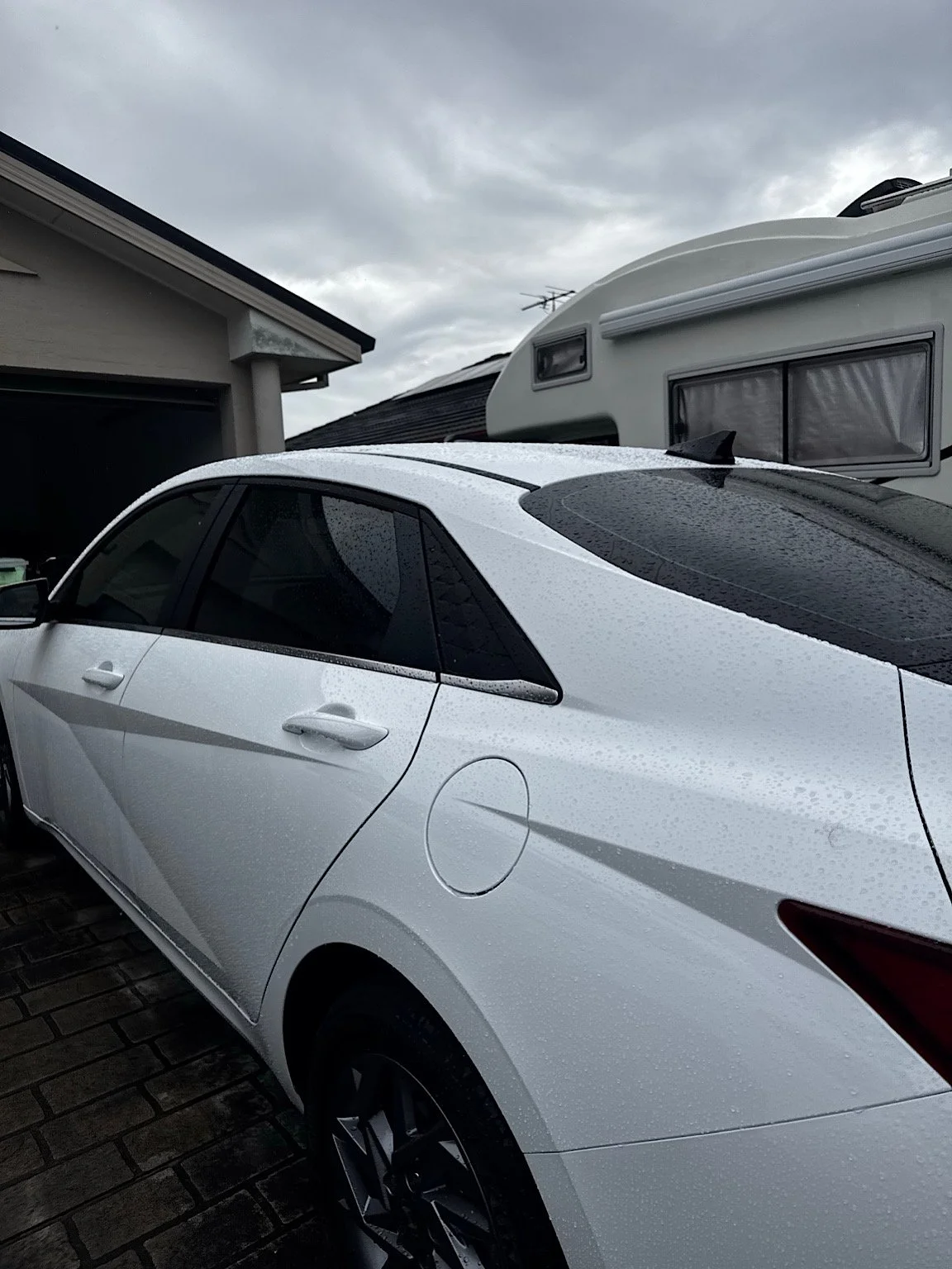 Rear three-quarter view of a 2026 Hyundai i30 Hybrid after professional mobile window tinting on the Central Coast NSW