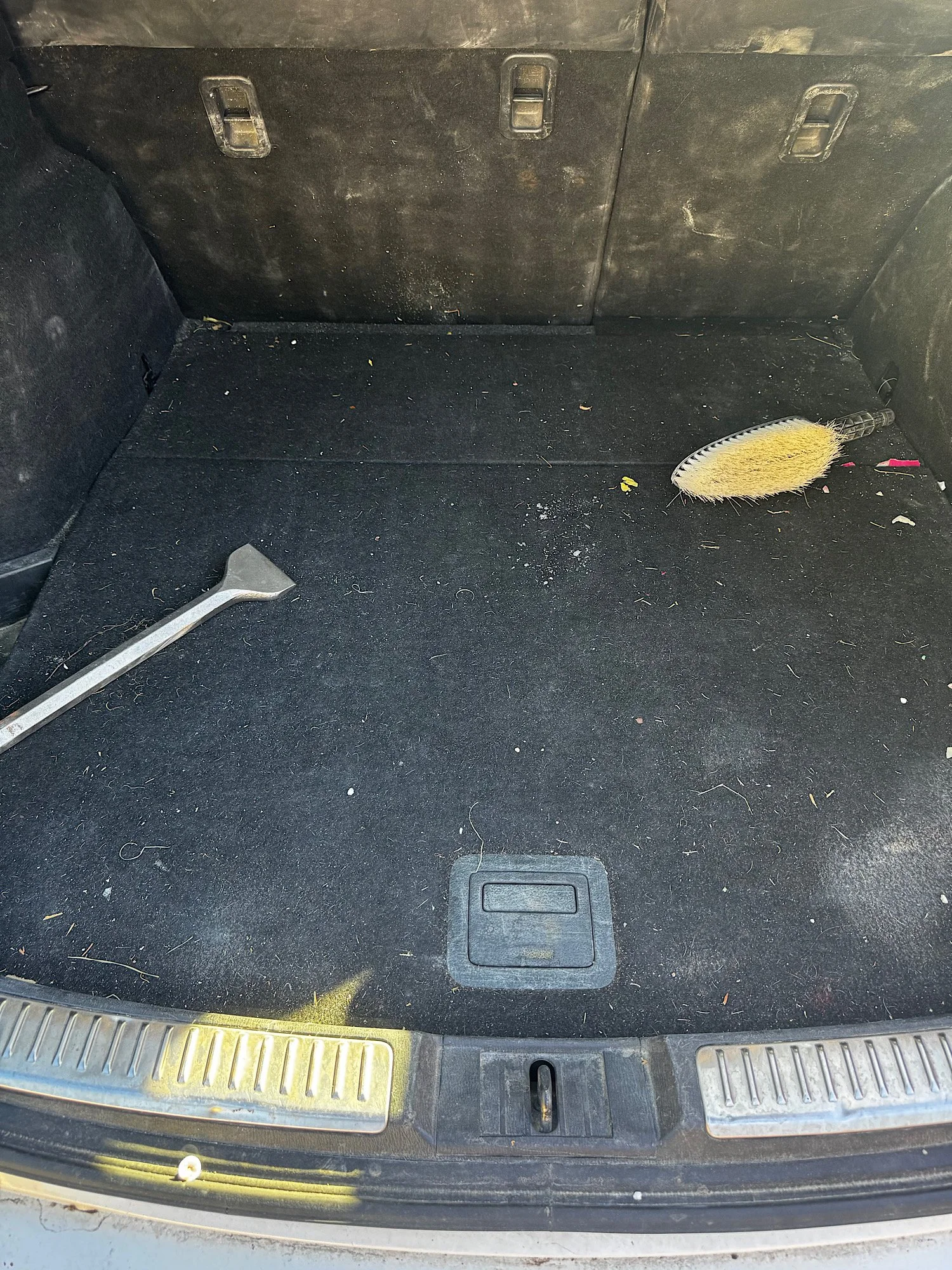 Dirty Mazda 6 boot area with debris and pet hair before detailing