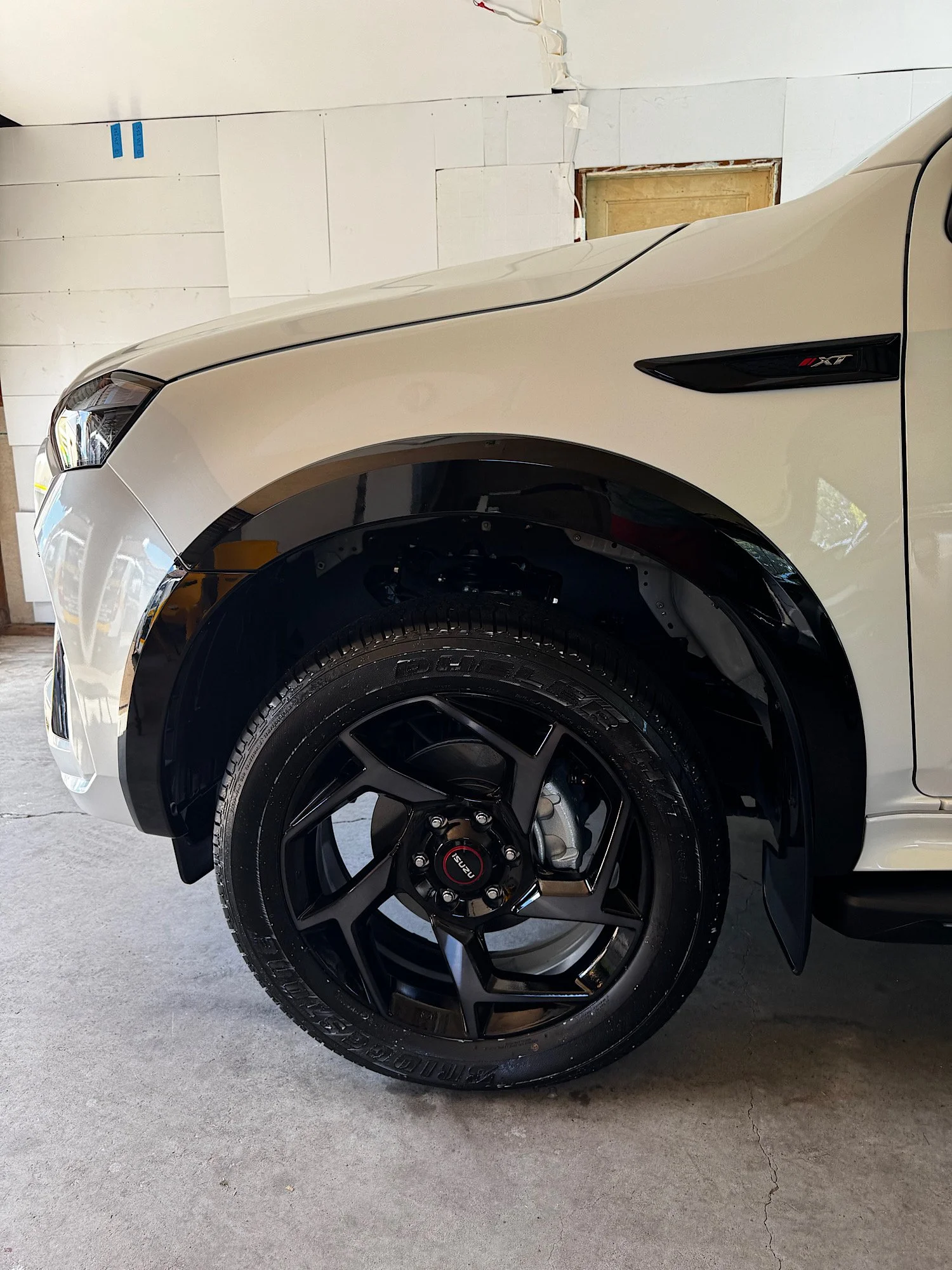 Gloss-black piano-finish wheel arch trim on a 2026 Isuzu MU-X after exterior trim protection at our Wyong studio