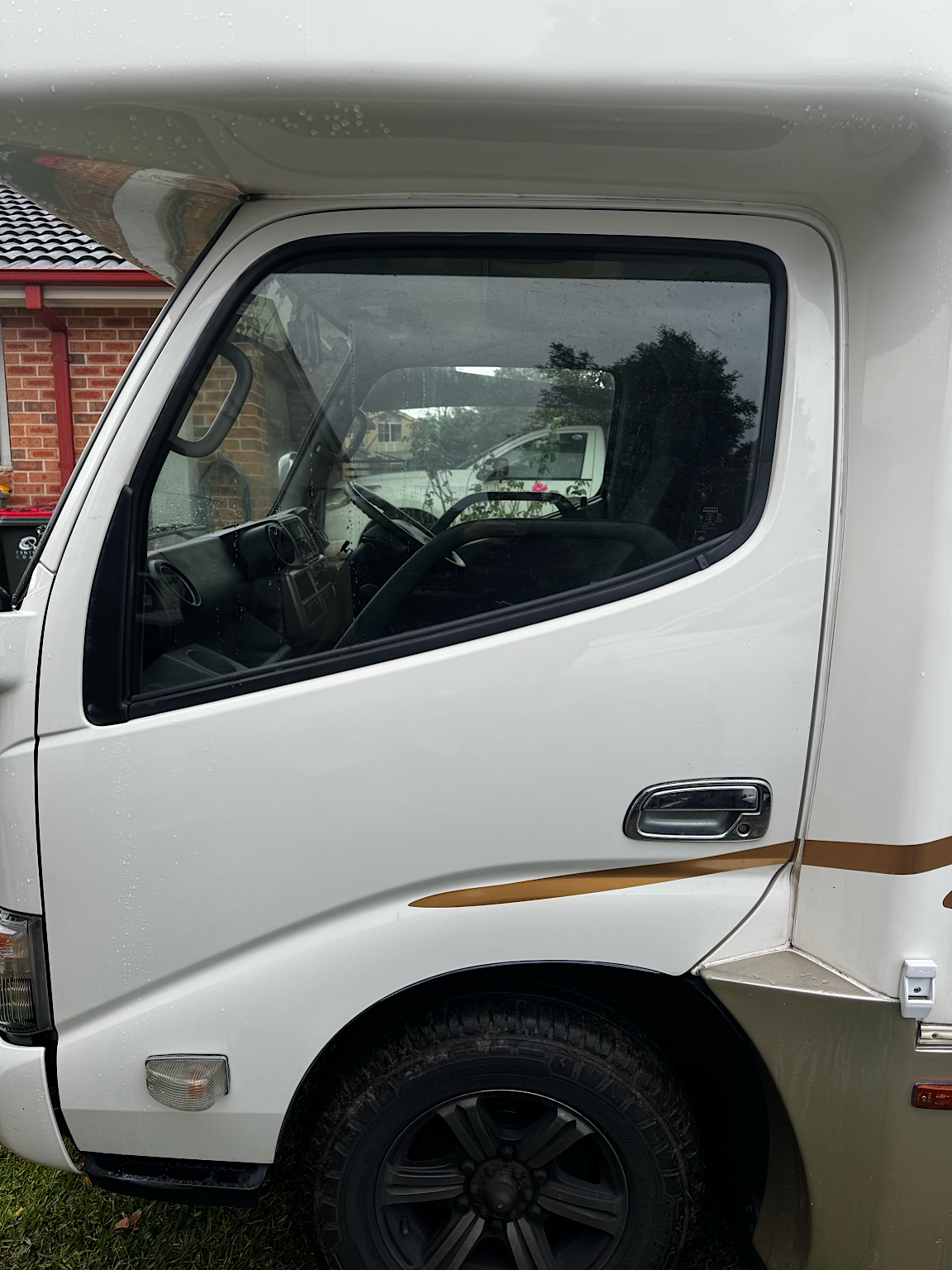 Before cabin window tint installation on a 2018 Toyota Camroad campervan in Hamlyn Terrace, NSW.