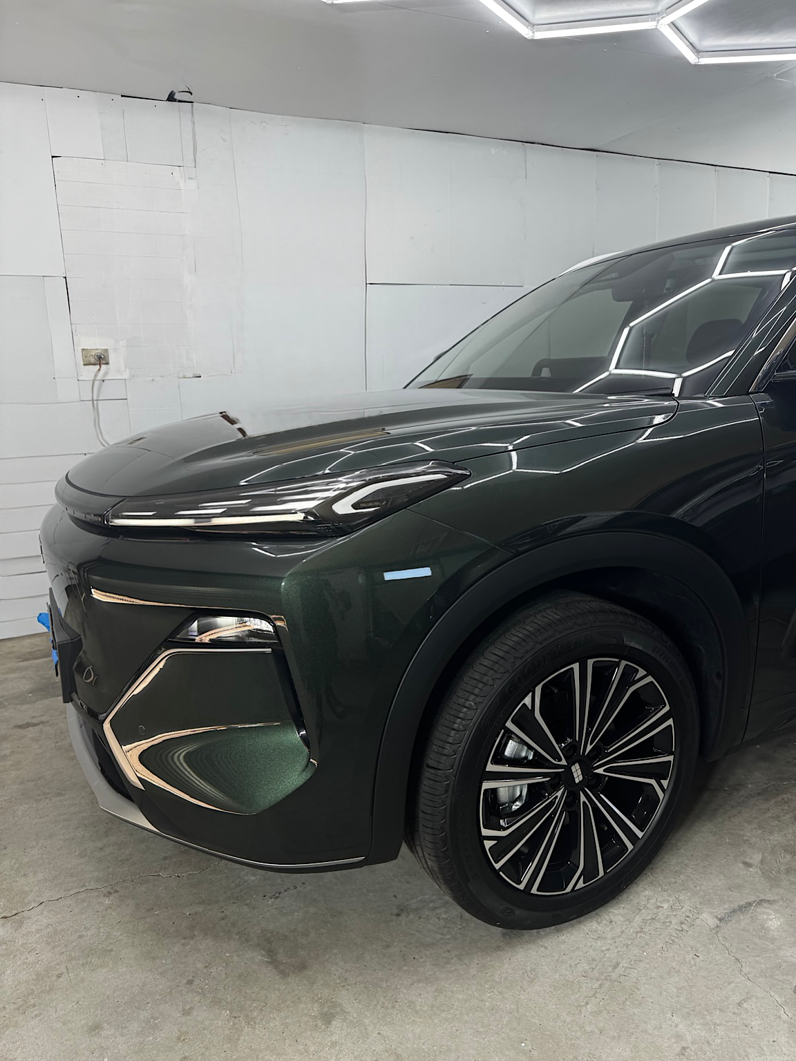 Close view of the Geely Starray EM-i front corner and glossy green metallic paint after ceramic coating