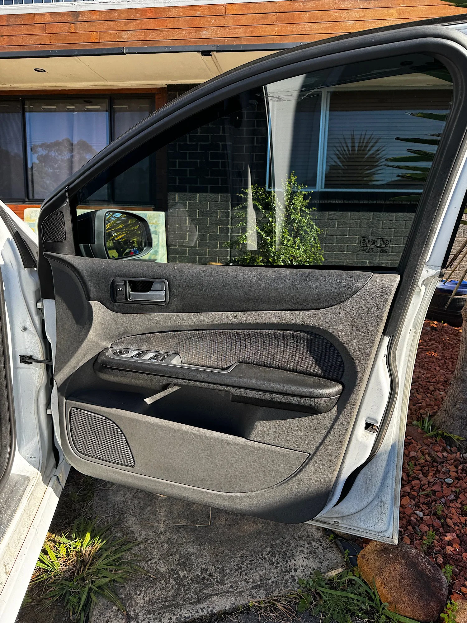 Driver door trim before cleaning during an extended interior detailing service.