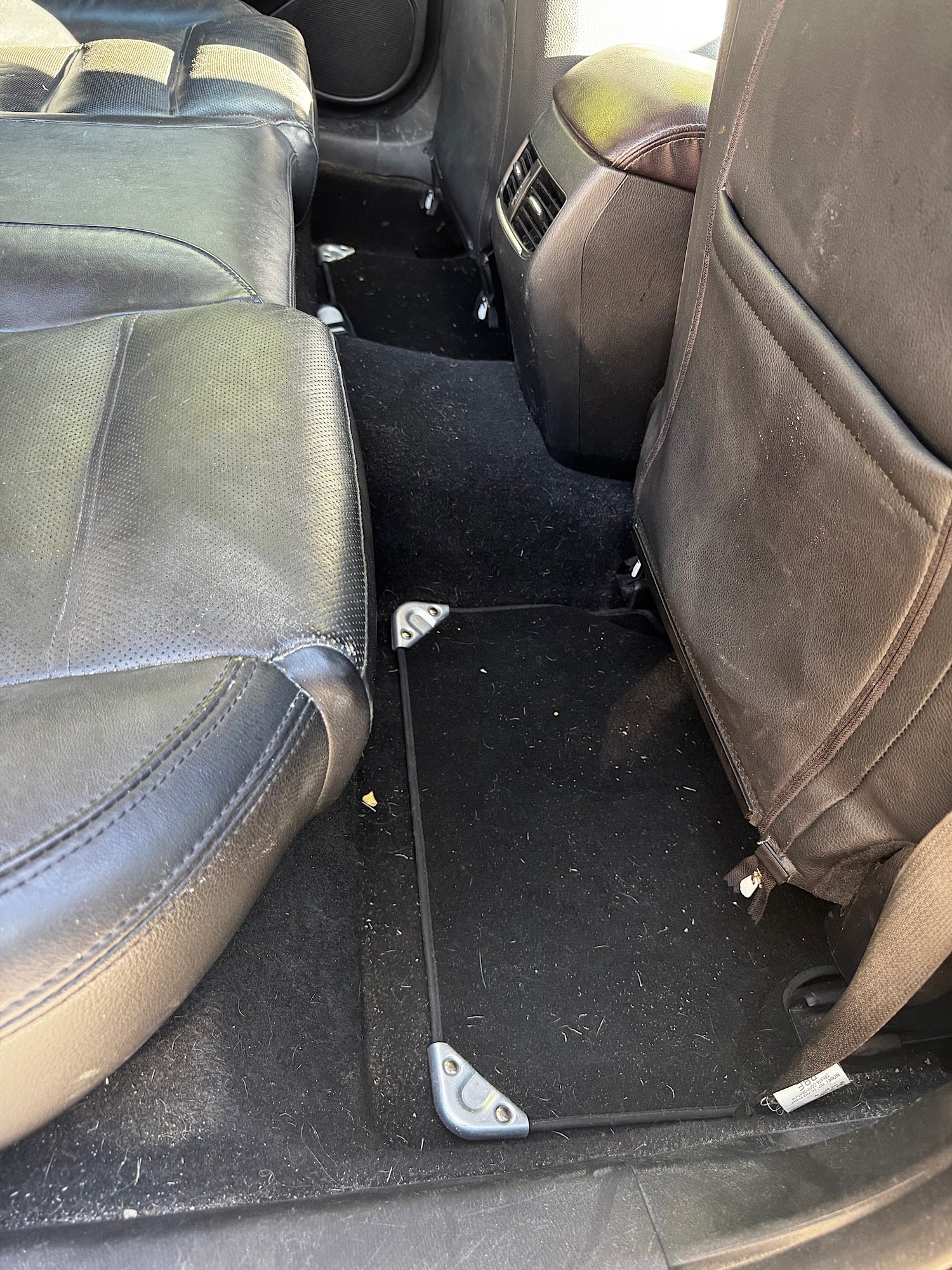 Pet hair build up in rear carpet of Mazda 6 before detailing