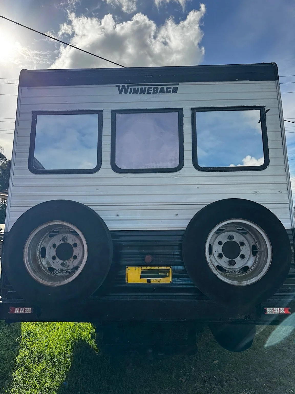 Rear windows of a Winnebago motorhome after silver reflective privacy tint installation