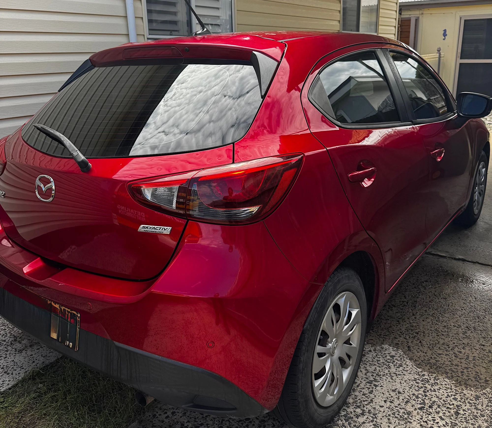 Mazda 2 Neo rear quarter view after window tint installation smooth finish