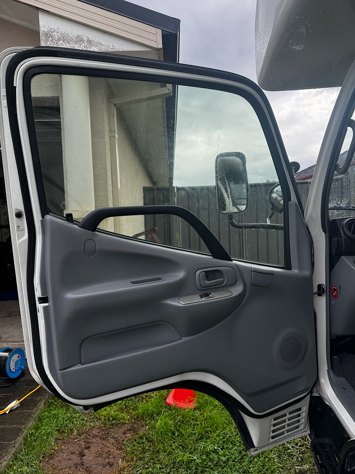 Interior view of the driver's door before premium window tint installation on a Toyota Camroad campervan.