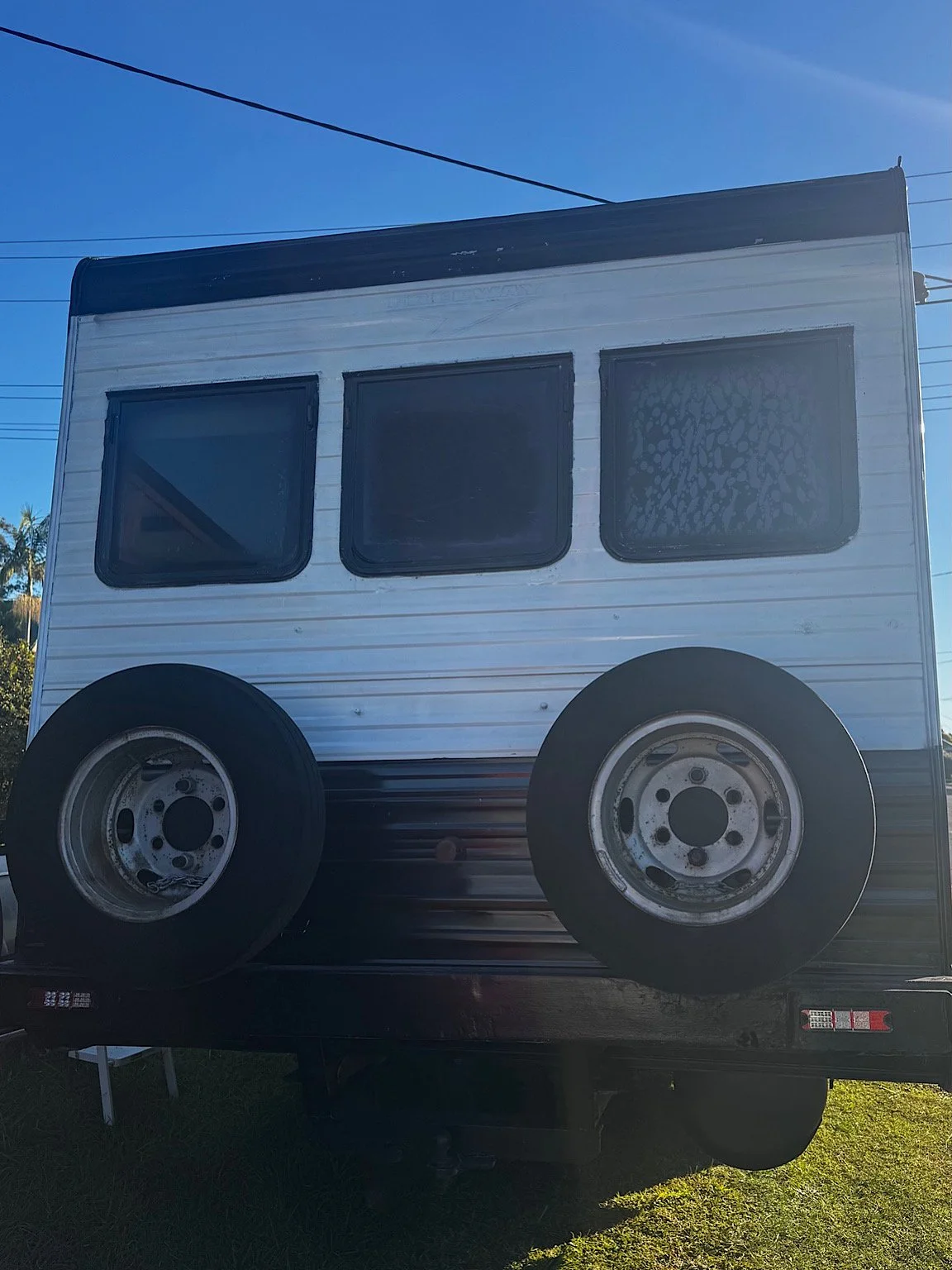 Rear windows of a Winnebago motorhome before privacy window tint installation