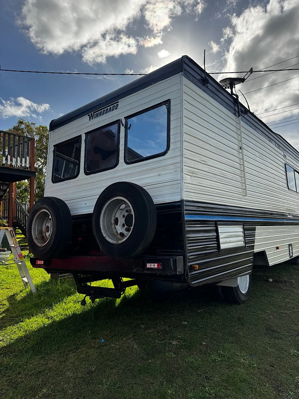 Rear three-quarter view of a Winnebago motorhome after professional window tinting