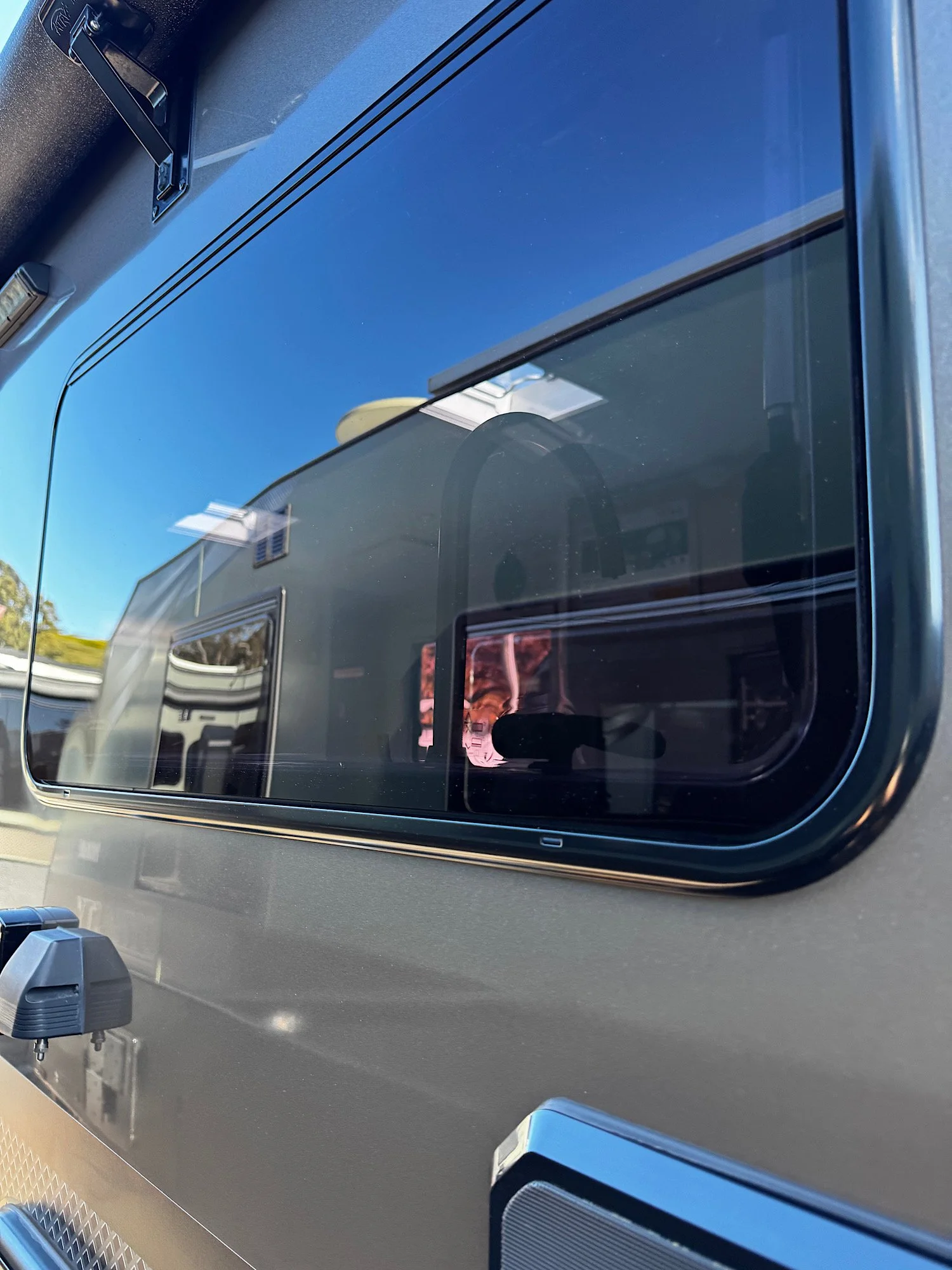 Caravan window surface after correction showing improved clarity and reduced swirl marks