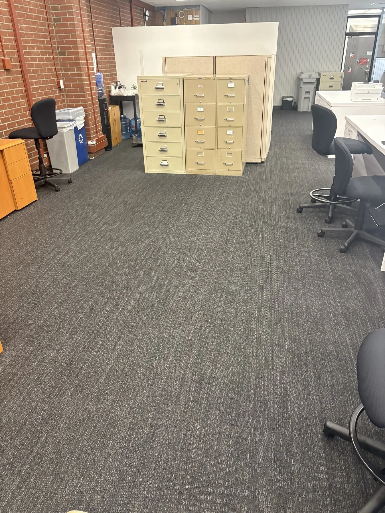Completed office-area Powerbond repairs at Grand Lake in Oakland, with the surrounding carpet retained.