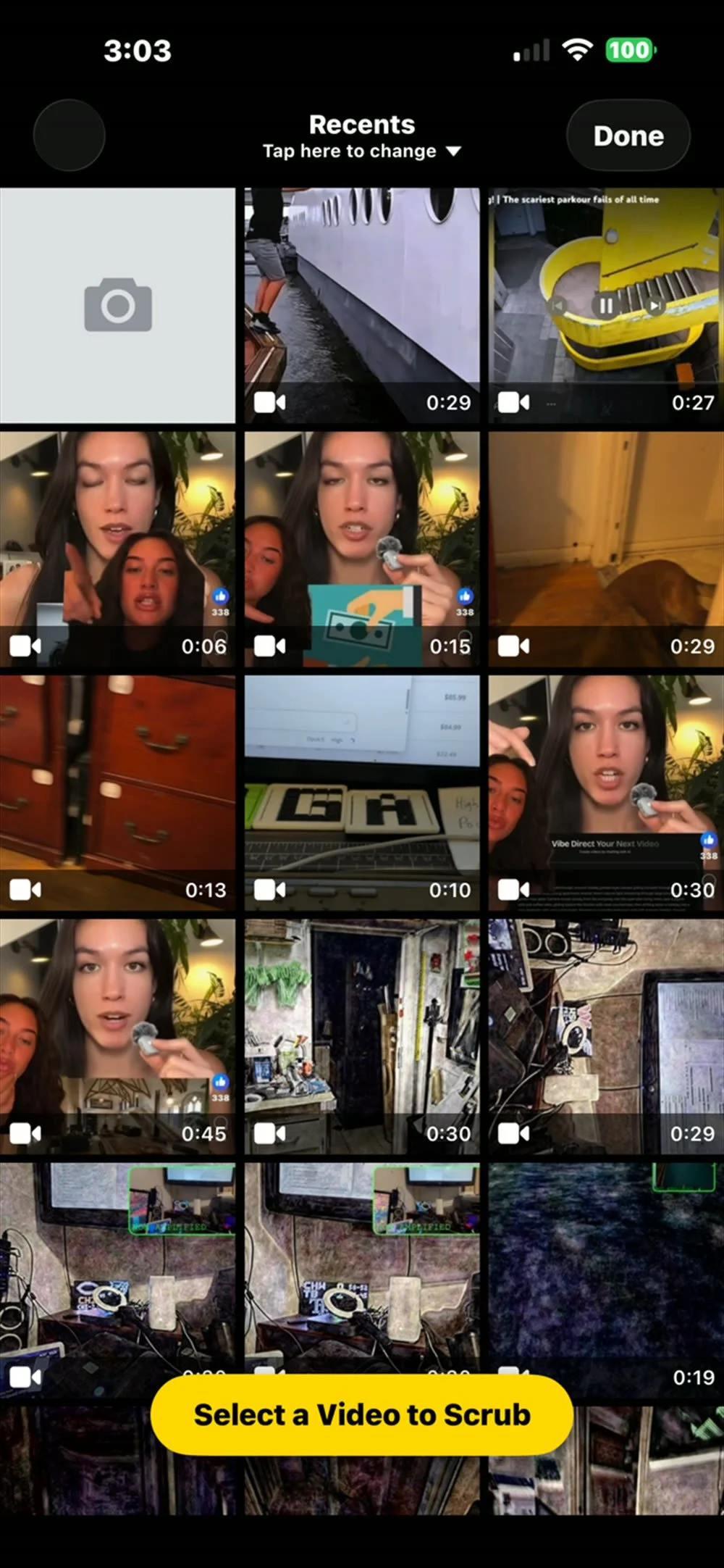 The video picker showing a grid of clips from the phone's camera roll with their durations, and a yellow Select a Video to Scrub button across the bottom.