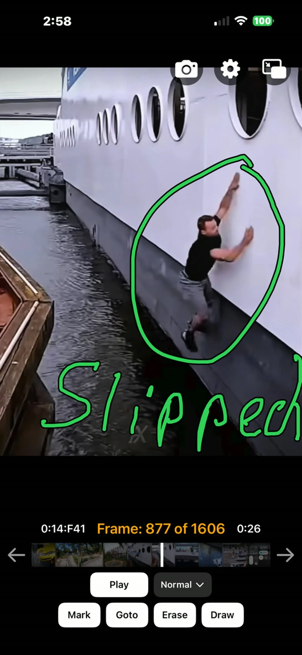 A frame of the clip with a green circle drawn around the figure and the word Slippery written beside it in the same green.