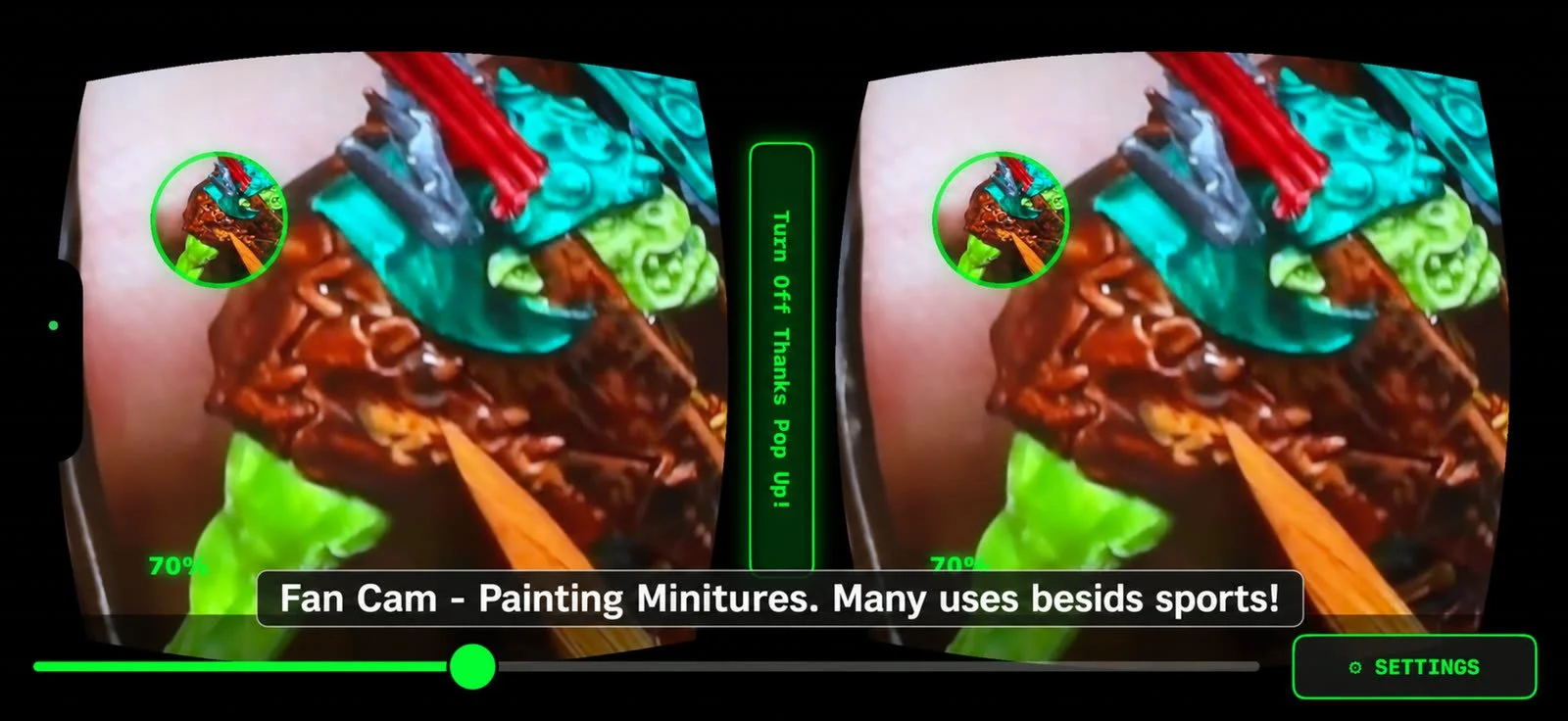 Through the headset at very close range: a brush laying paint onto a hand-held miniature figure, the detail blown up large in both eyes.