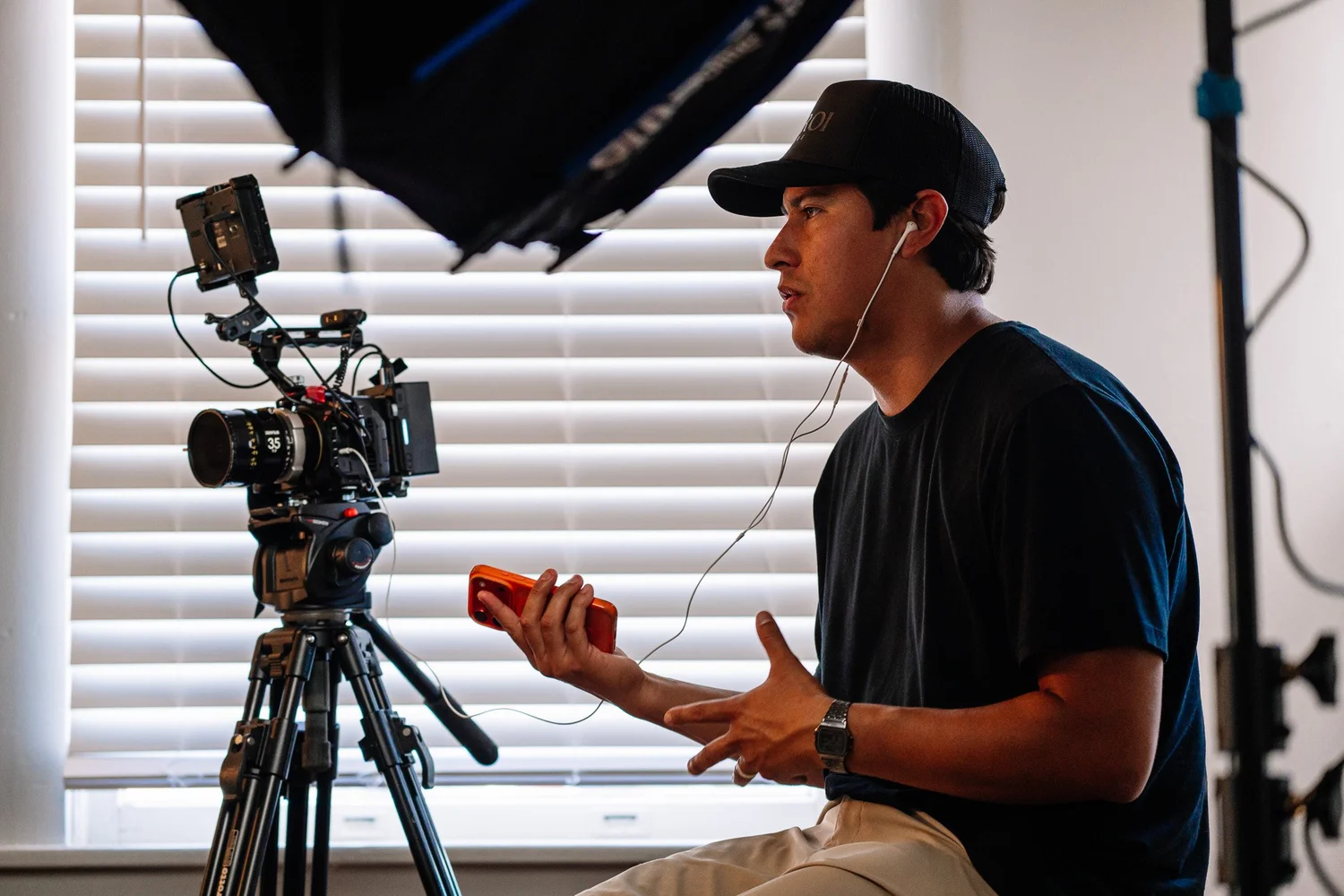 Andres Hernandez conducting a documentary interview beside a cinema camera