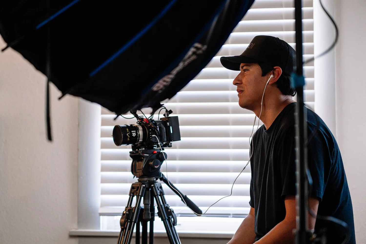 Andres Hernandez on set beside a cinema camera