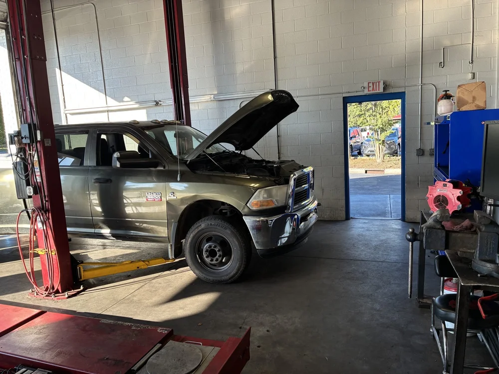 A RAM pickup raised on a lift in the shop