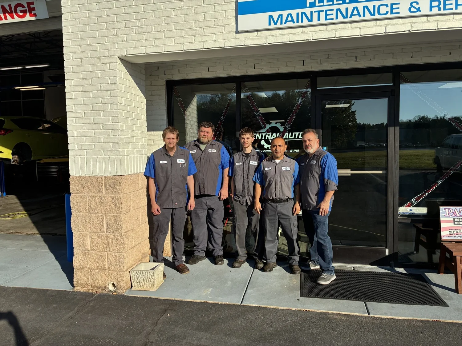 The Central Automotive team standing together outside the shop entrance